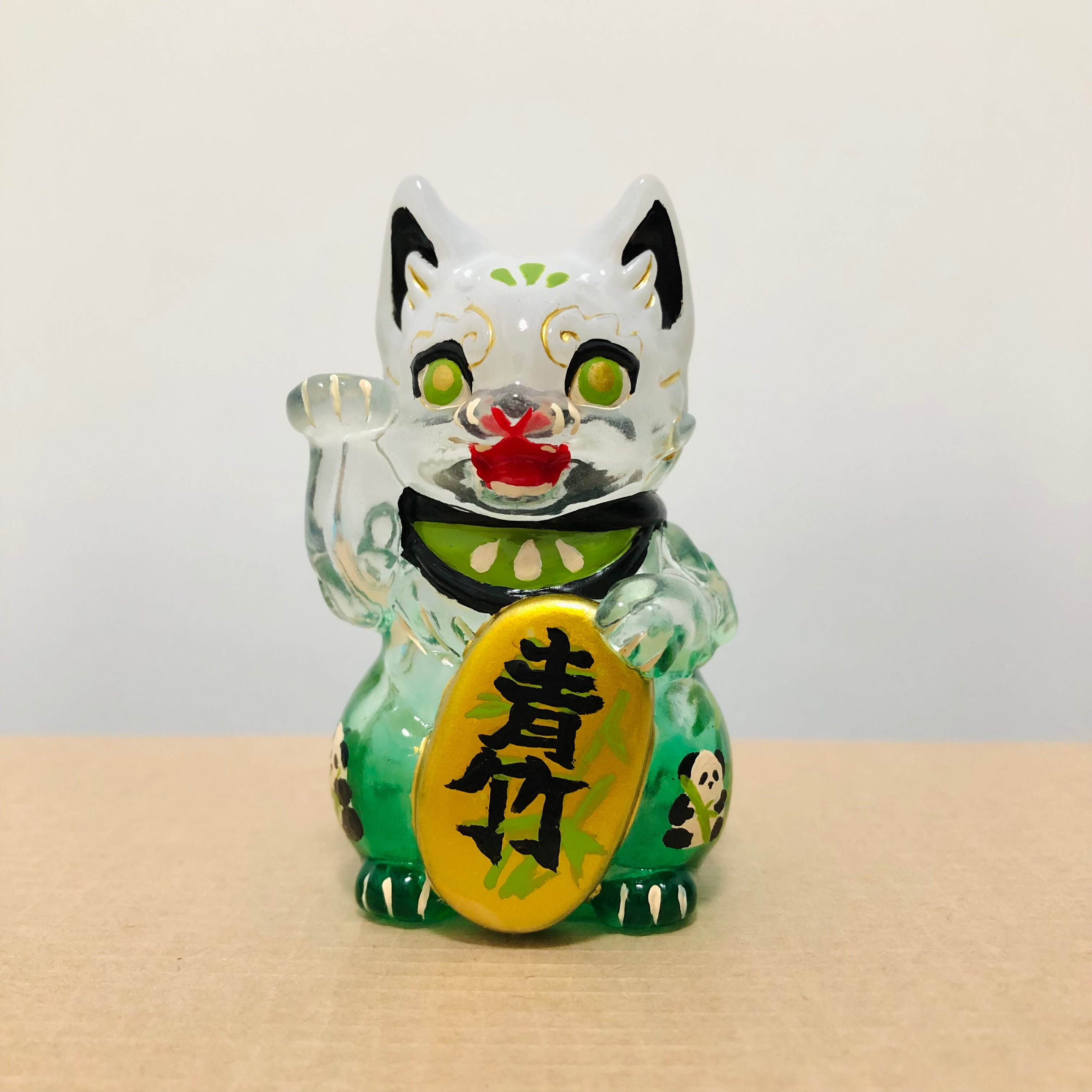 Bake Lucky Cat figurine, small vinyl toy of a cat with gold sign, close-up details.