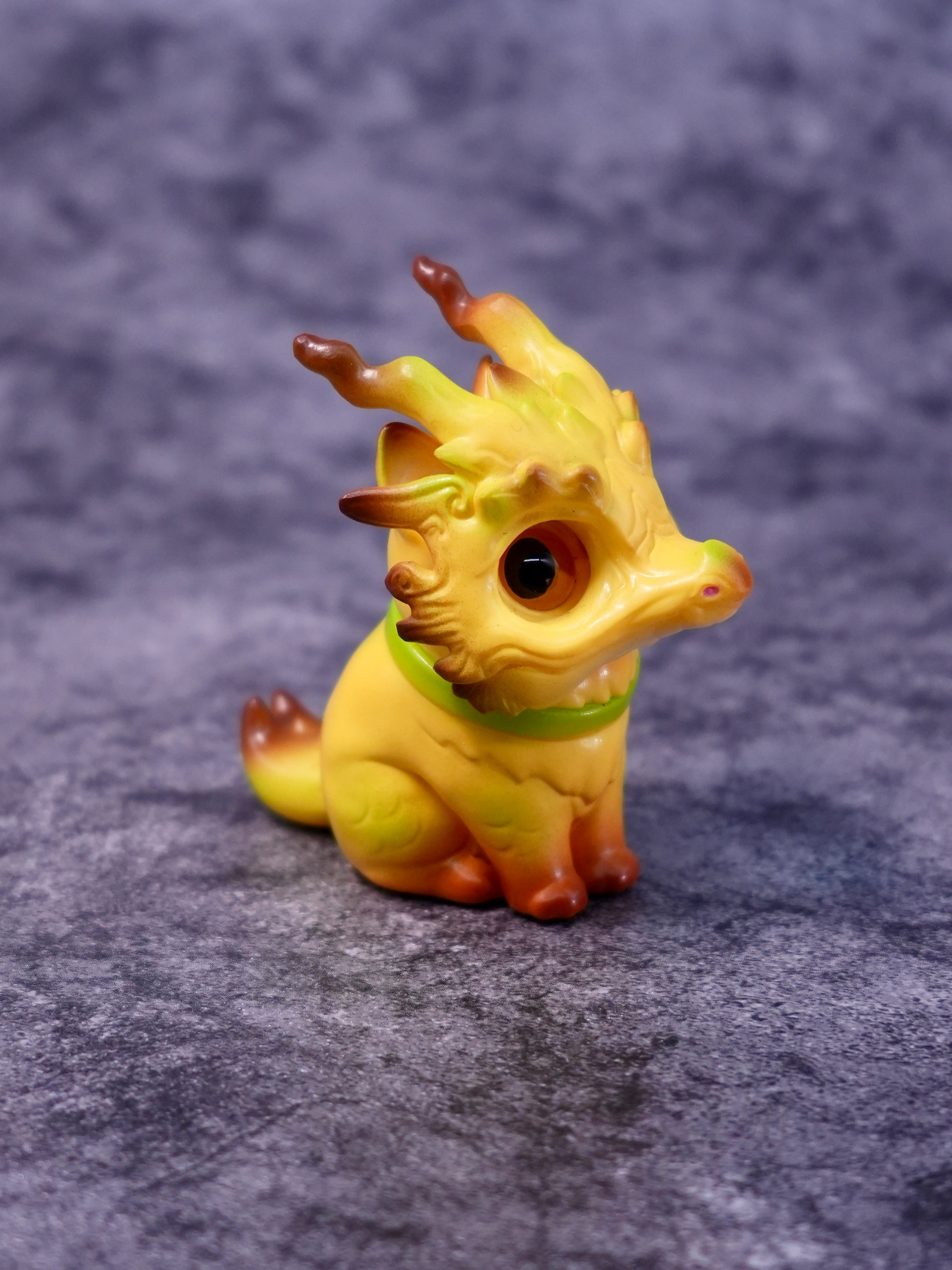 Banana Loong cat by HOTRU: A yellow-orange dragon-puppy figurine with big eyes, rotatable head, and removable resin mask. Preorder for May 2026.