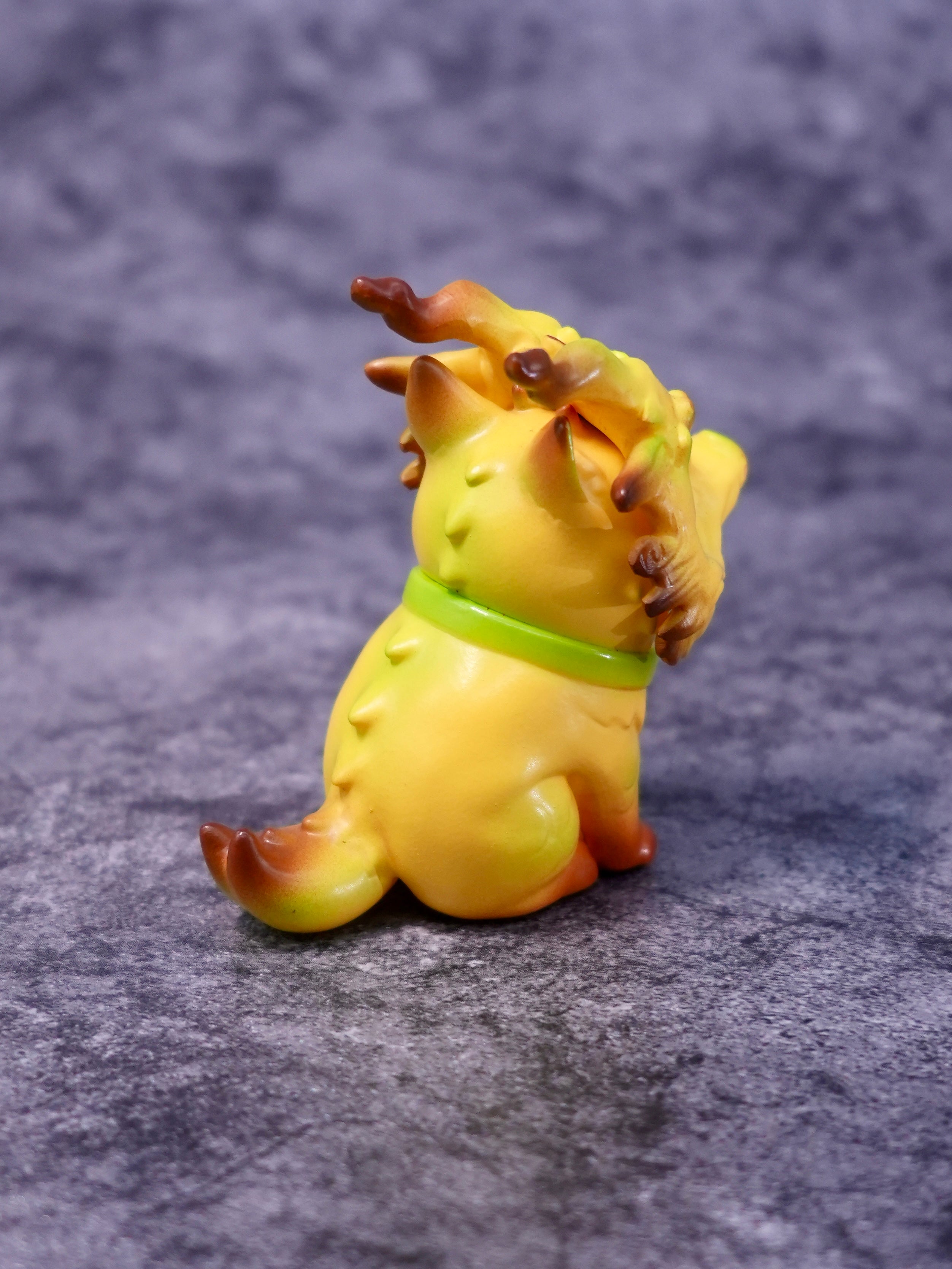 Banana Loong cat figurine by HOTRU, featuring a cat-dragon hybrid with antlers, painted in warm tones with a green collar. Preorder for May 2026 delivery.