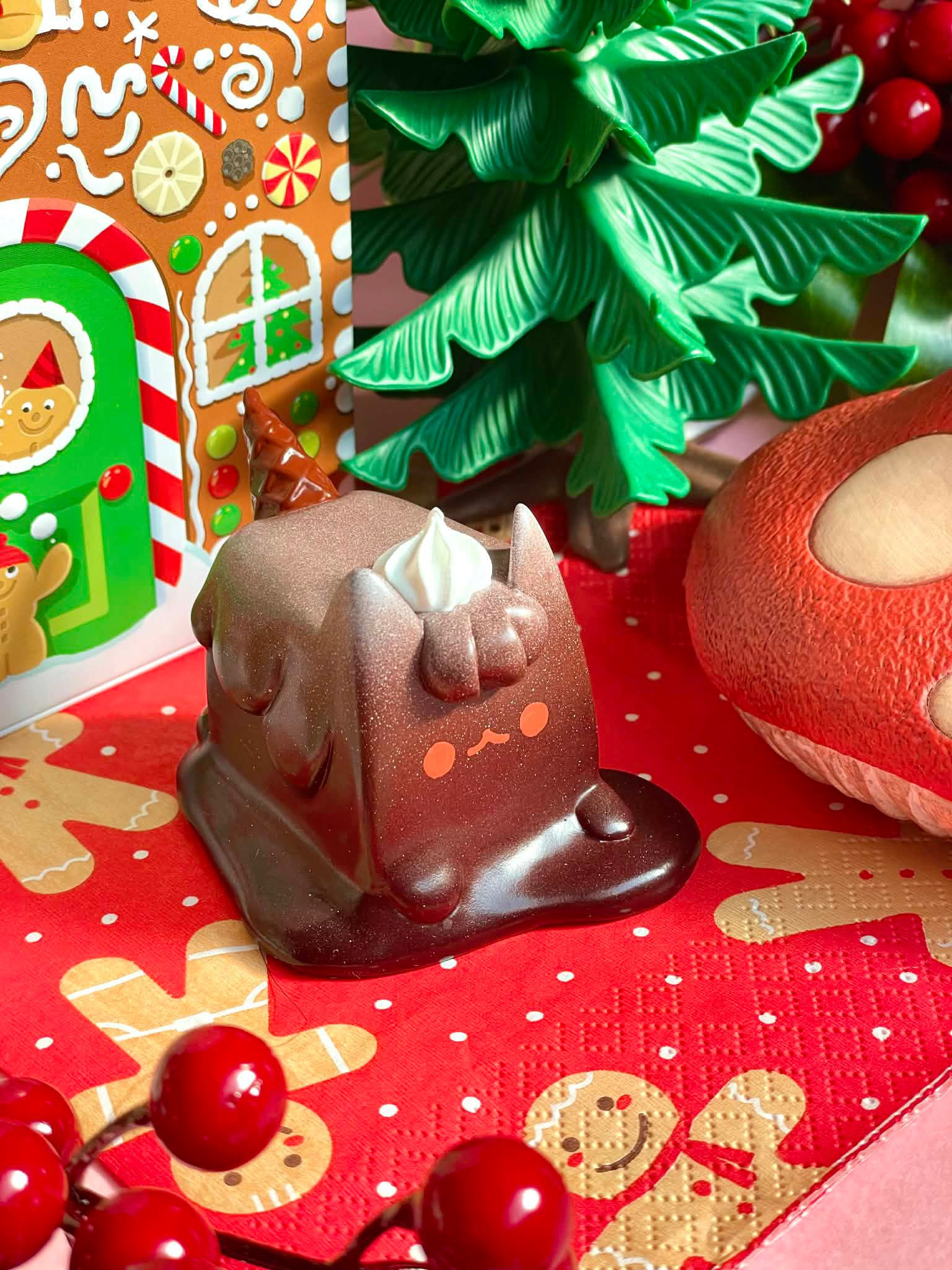 Ice Cream Cat (Brownie ver) by Rato Kim, a melting chocolate cat figure with unicorn details, on a festive napkin; available for preorder.