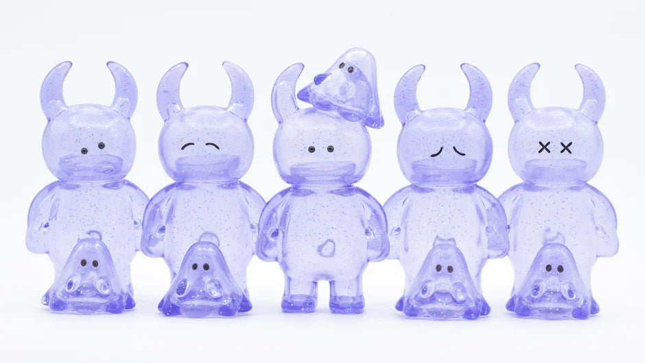 UAMOU CLEAR LAVENDER GLITTER figures, featuring ten translucent, glittery vinyl toys with unique expressions; horned creatures paired with smaller ghost characters, each 7cm tall.
