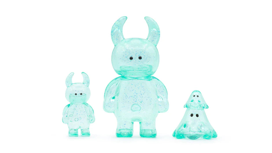 UAMOU CLEAR MINT GLITTER: Three teal-blue designer toy figures with sparkles, featuring two horned creatures and a ghost-like shape, made from glittery soft vinyl.