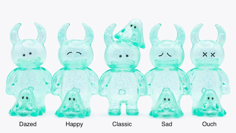 UAMOU CLEAR MINT GLITTER figures with bunny ears and expressions: Dazed, Happy, Classic, Sad, and Ouch, each paired with a matching blob companion.