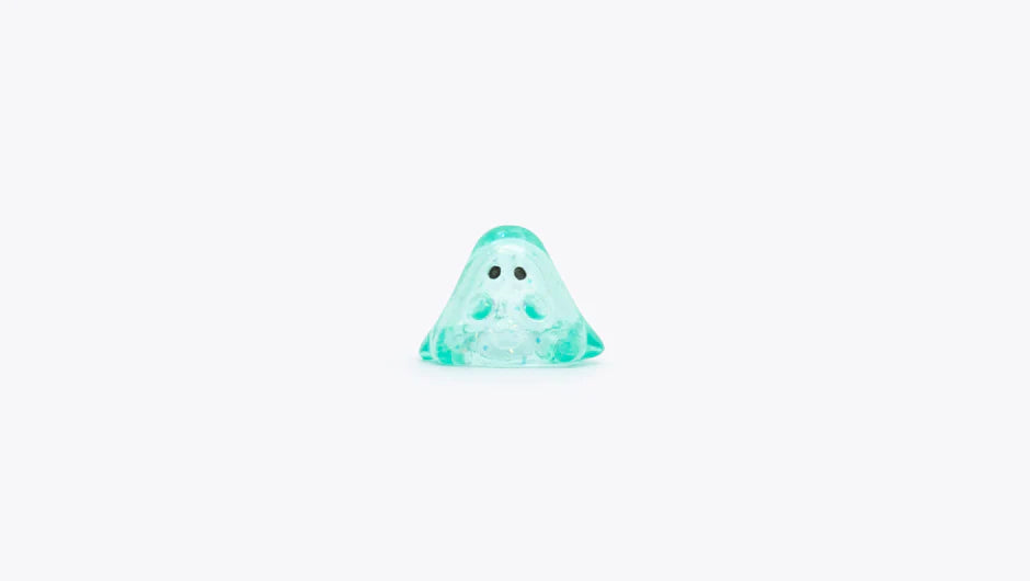 MINI BOO CLEAR MINT GLITTER: 1cm translucent ghost figurine with black eyes, crafted from soft vinyl in Japan, embodying Strangecat Toys' unique art toy offerings.