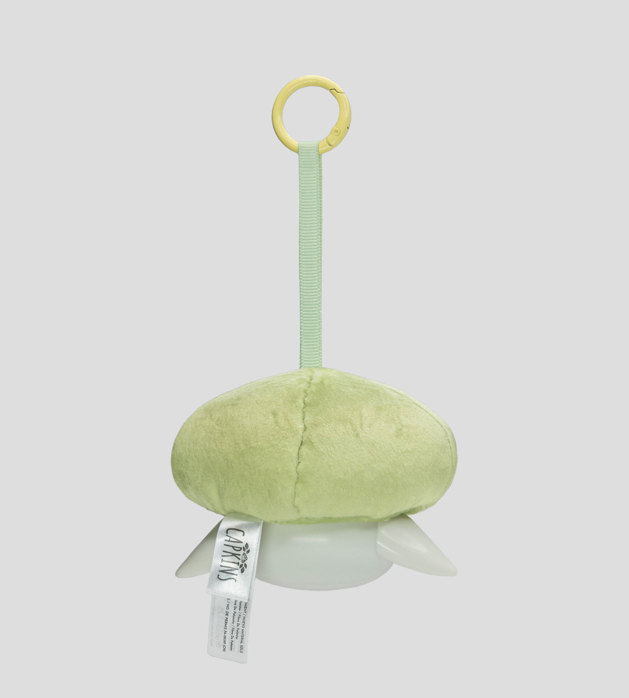 Capkins - Plush Bag Clip features a pale green plush body with plastic flippers and a yellow clip, designed for strollers or bags. Preorder available.