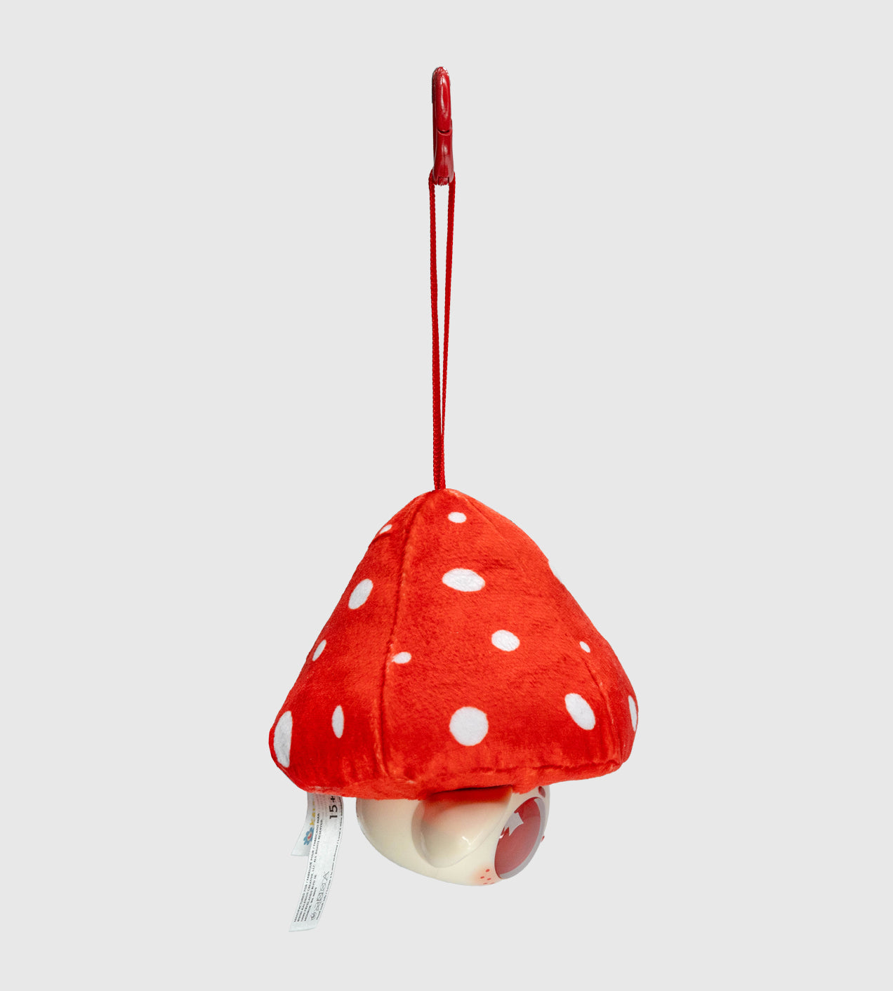 Capkins - Plush Bag Clip: A small, mushroom-shaped toy with a red cord, plastic clip, and round plastic housing, part of Strangecat Toys' art collection.