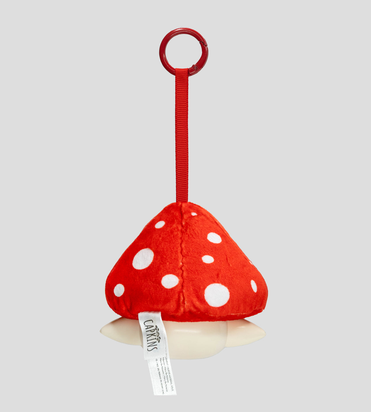 Capkins - Plush Bag Clip: Red-and-white mushroom plush toy with a red strap and plastic ring, designed for easy attachment to strollers or cribs.