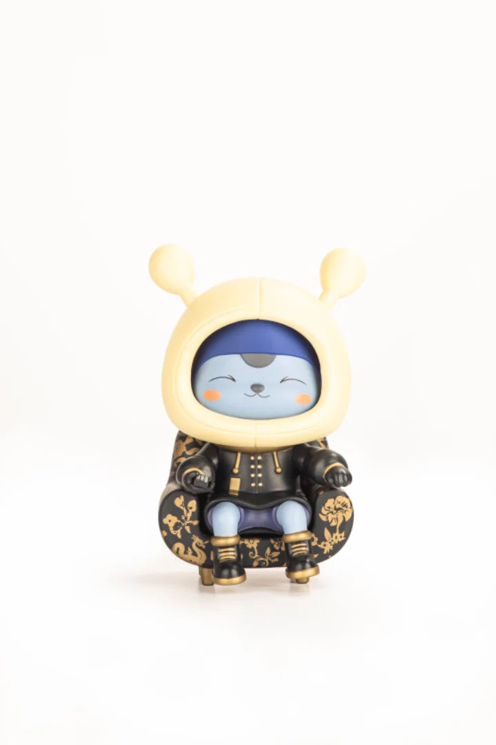 Napa - Obsidian: A limited edition vinyl art toy of a smiling, cat-like character in a gold-accented outfit, seated in a decorative armchair.