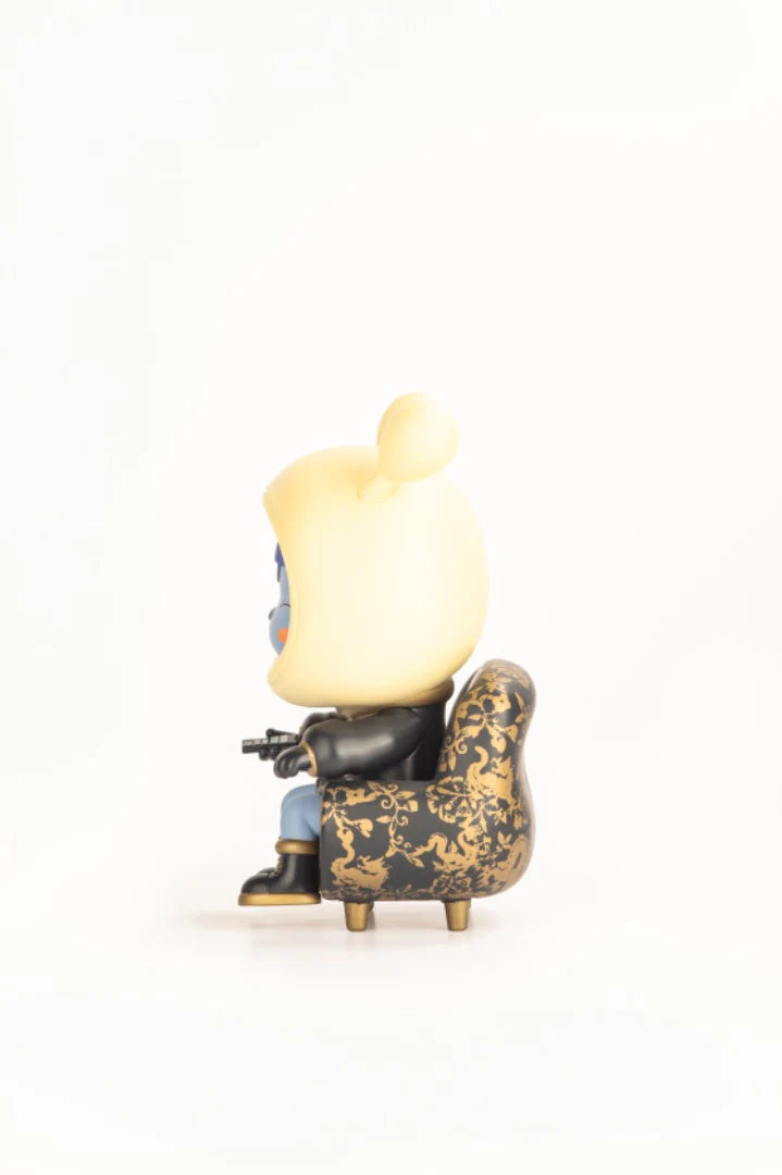 Napa - Obsidian: A limited edition collectible art-toy figure in a black jacket, sitting on a baroque-patterned armchair, holding a tiny weapon.