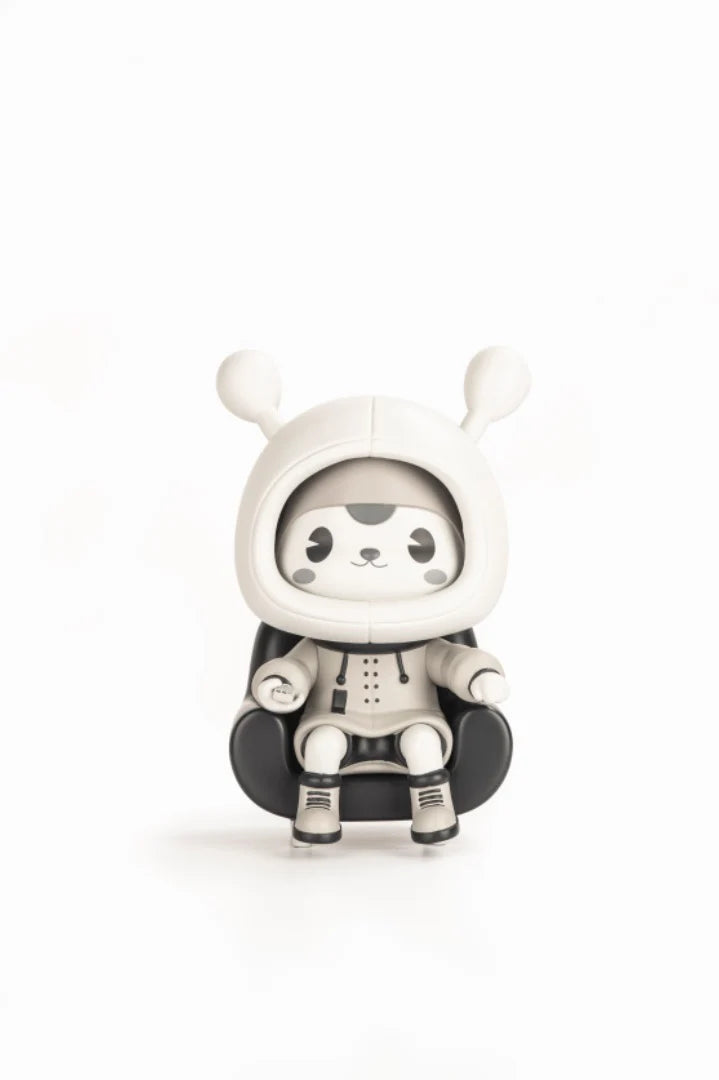 Napa - Retro vinyl art toy, a panda-rabbit hybrid in a hooded outfit, seated on a black chair, inspired by classic black and white animation.