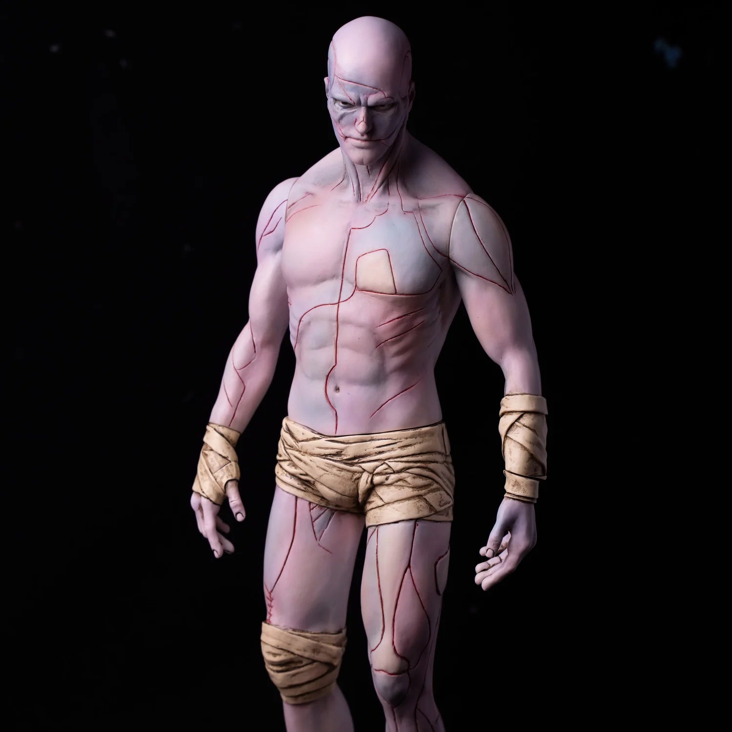 Frankenstein: The Creature V1, a 30cm soft vinyl figure, showcases a stylized, muscular form with red vein-like patterns and tattered cloth-wraps.