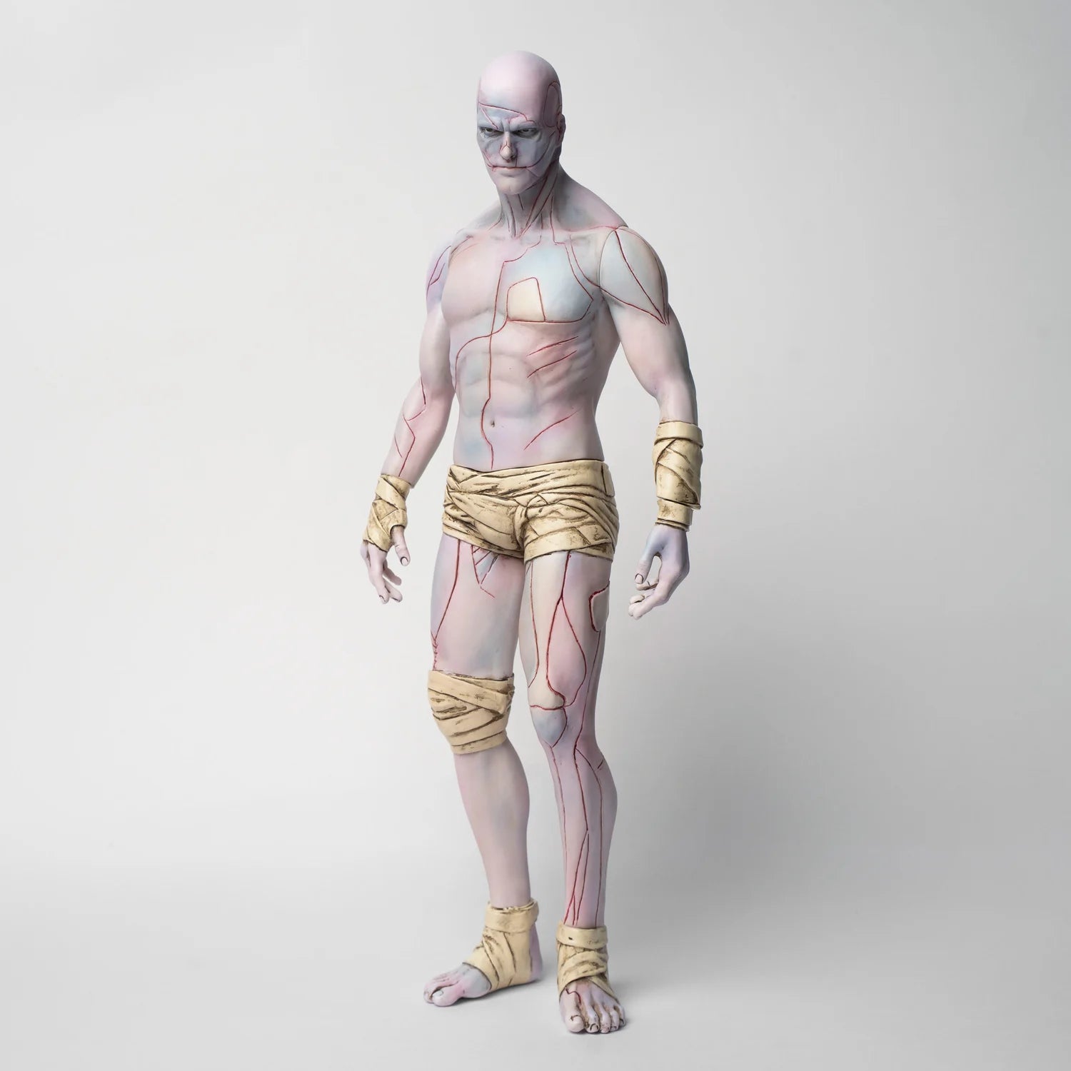 Frankenstein: The Creature V1, a 30cm soft vinyl figure, blends anatomical artistry with minimalist design, featuring pale skin, colored lines, and wrapped bandages.
