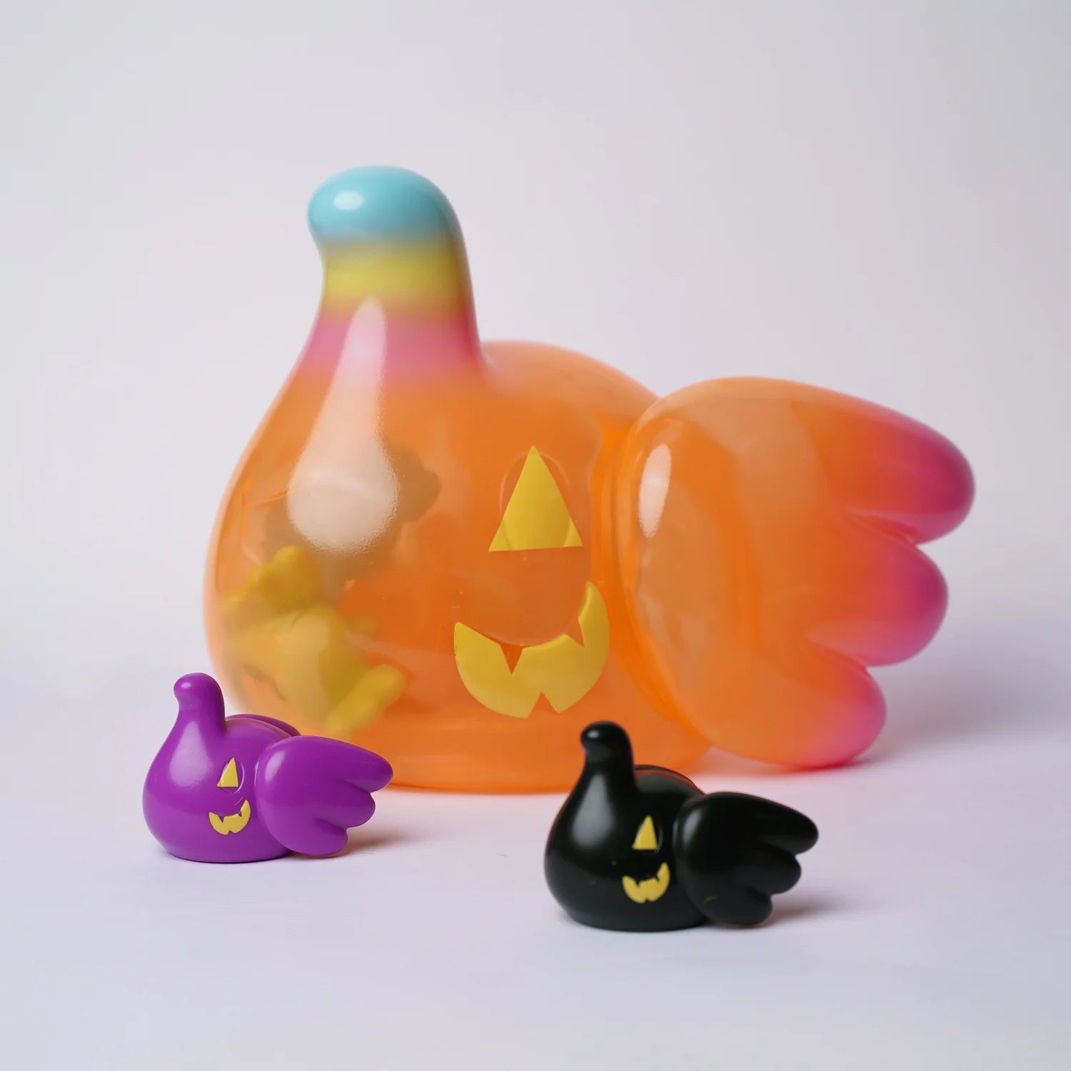 ELFIE PUMPKIN HEAD EDITION - Preorder: Three playful, Halloween-themed collectible figures, featuring a large translucent blob and two smaller solid-color blobs with jack-o’-lantern faces.