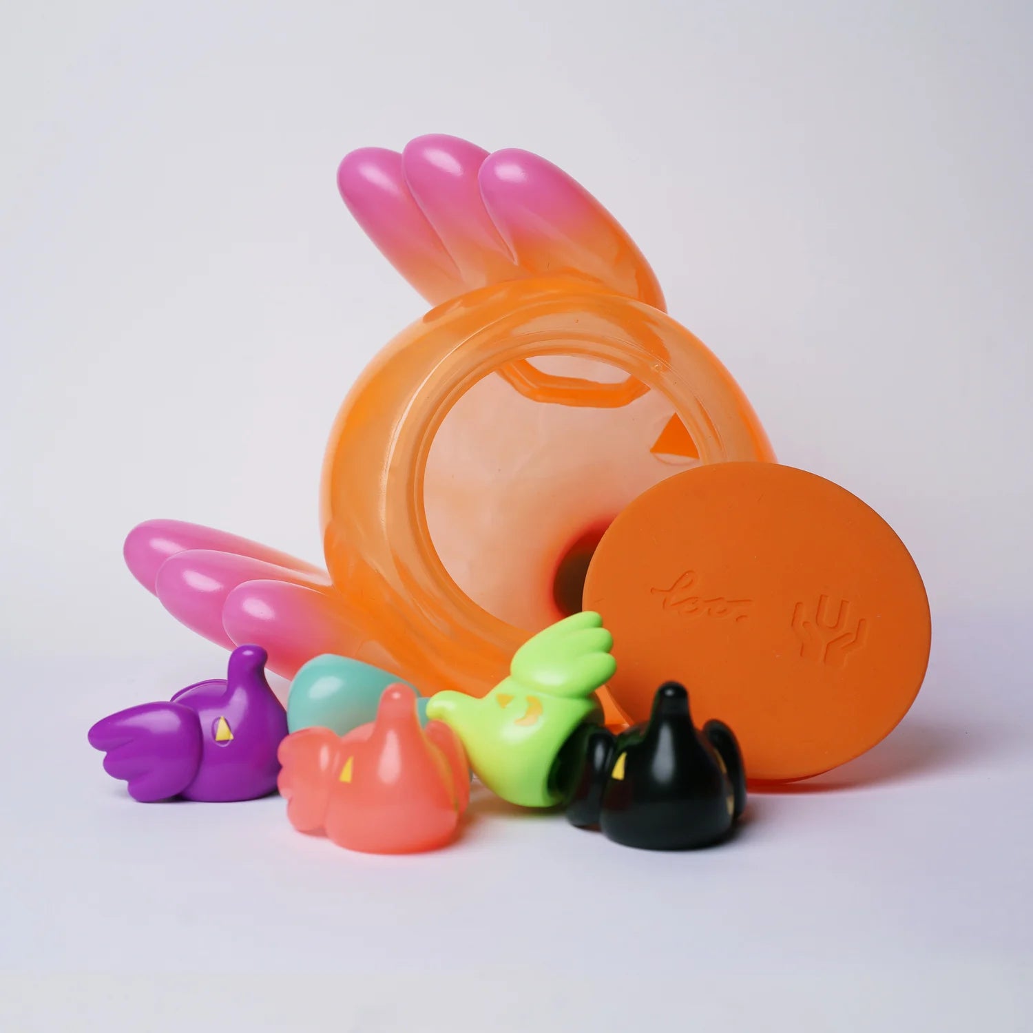 ELFIE PUMPKIN HEAD EDITION - Preorder: Orange jar with colorful silicone ear tips for headphones, emphasizing playful design and collectible art toy style.