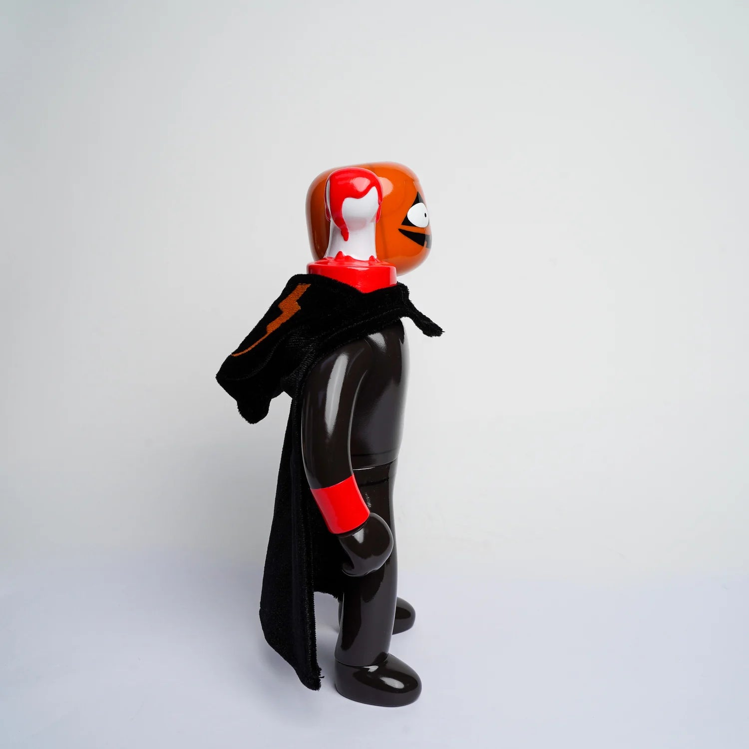 MR NOBODIES (HEADLESS HORSEMAN) vinyl art toy with an oversized head, red accents, and a cape, designed by Lick Palik, available for preorder.