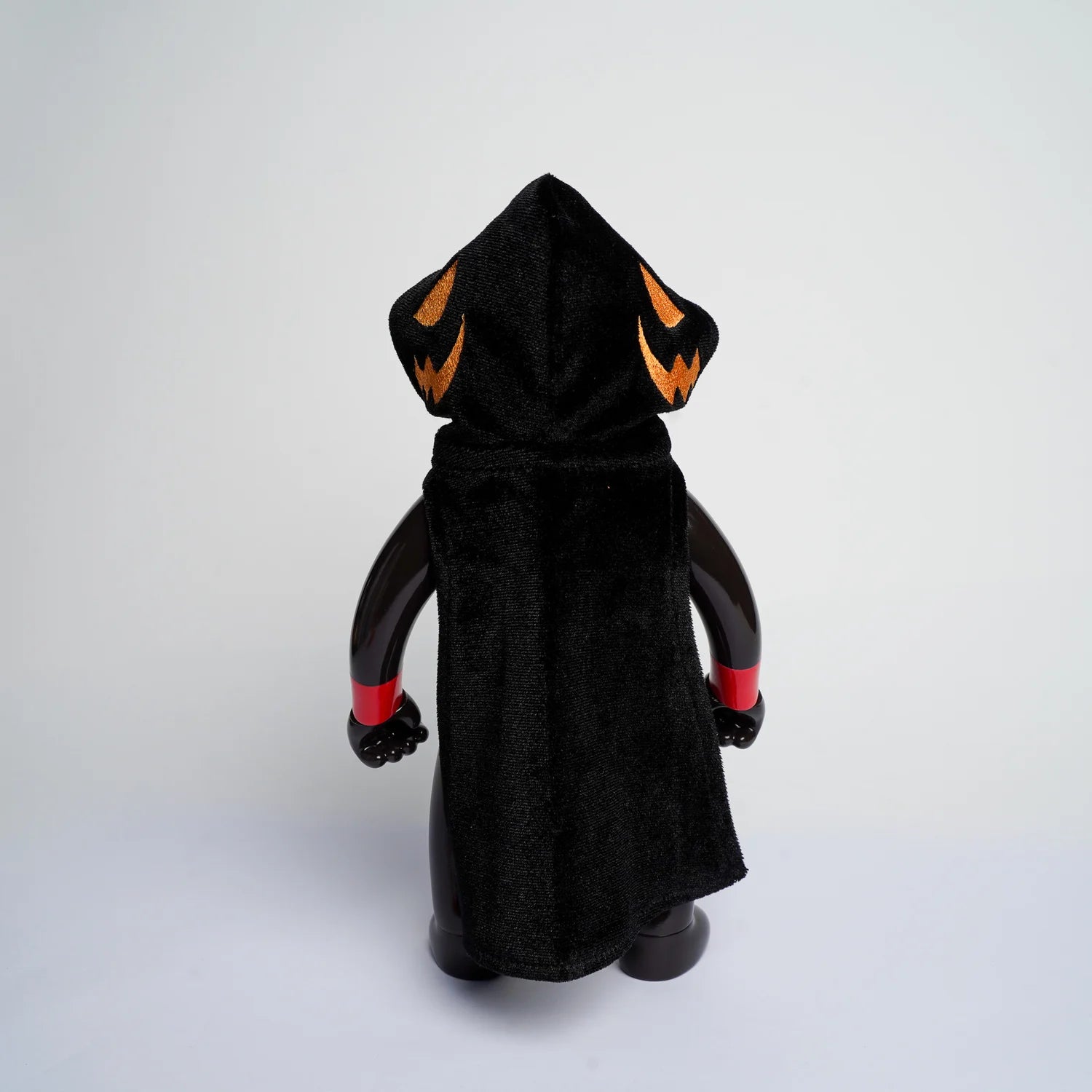 MR NOBODIES (HEADLESS HORSEMAN) figurine with black cloak, orange jack-o'-lanterns, and red wristbands, embodying quirky art toy design.