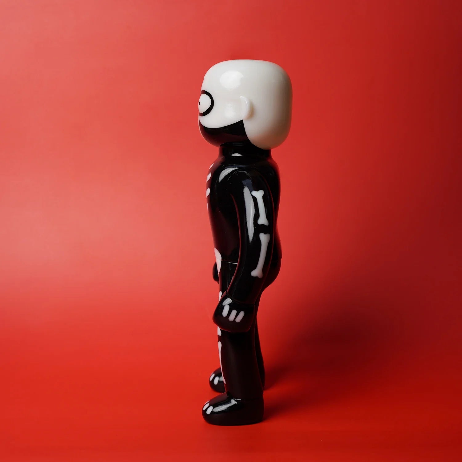 Mr. Nobodies - Skeleton (GID Green) vinyl toy, featuring a glossy black skeleton design with white bone details, designed by Lick Palik. Preorder available.