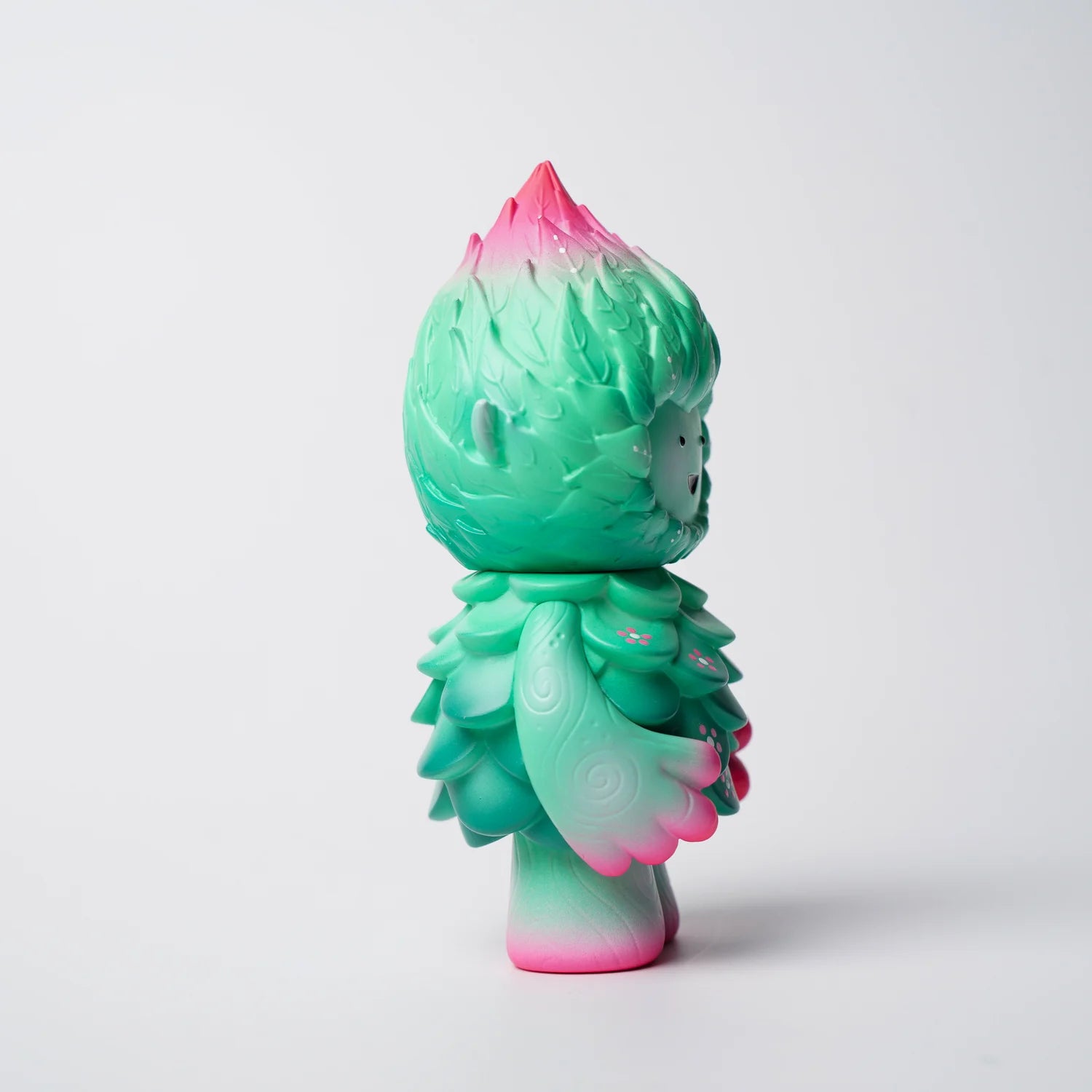 MUJUWORLD TREE SPIRIT SPRING EDITION - Preorder: A whimsical 4 vinyl figure with leaf-like scales, gradient mint to pink, featuring a joyful face and topped with a pink bud.