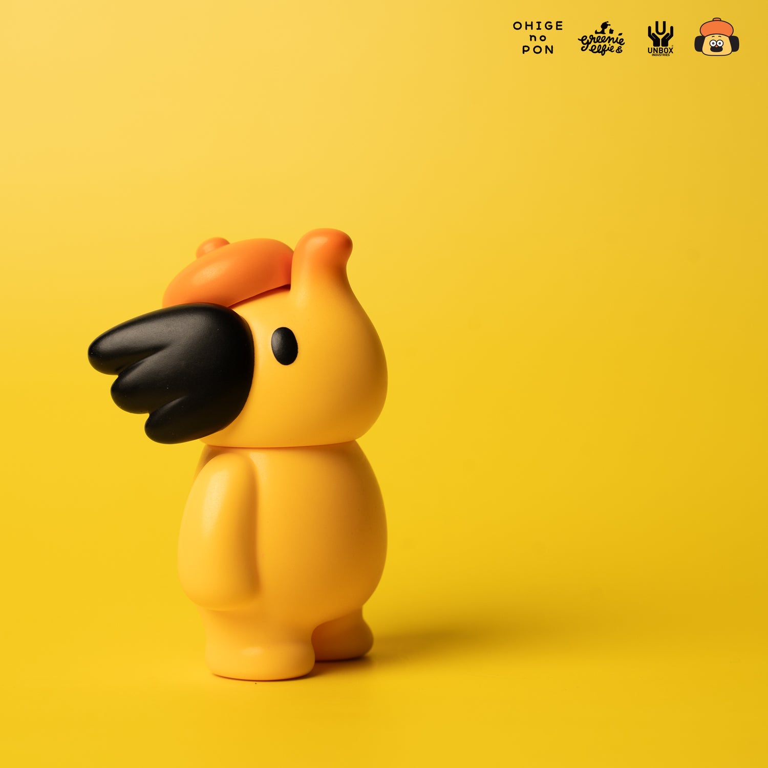 ELFIE HERE I AM! 100% OHIGEnoPON EDITION vinyl figure with orange cap and black mask detail against yellow background. Branded collectible from Strangecat Toys.