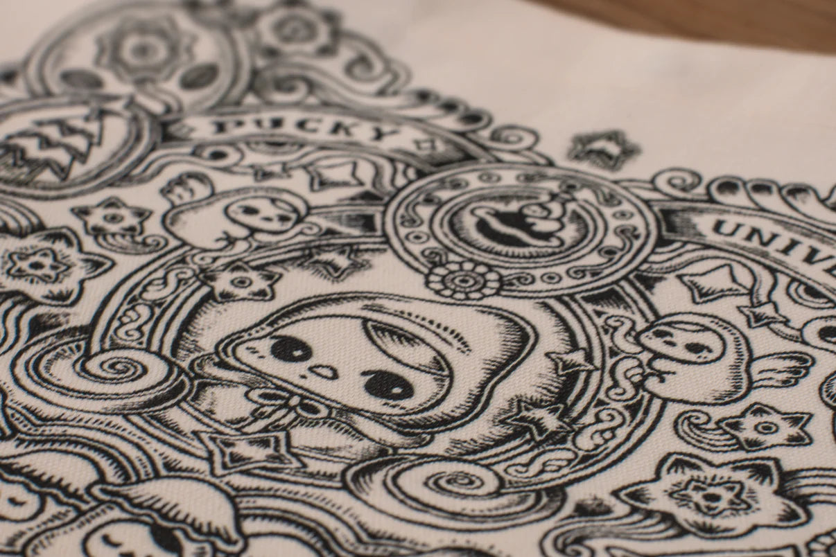 Tote bag - Pucky Universe - Preorder features a kawaii cartoon figure with ghost motifs and medallions on cotton canvas, emphasizing playful, doodle-style art.