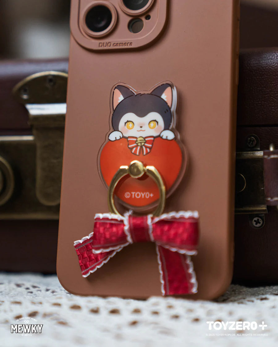 Moffy's - Mewky Phone Ring Holder - Black Cat on heart-shaped plate with gold ring, red bow, set against a lace tablecloth.