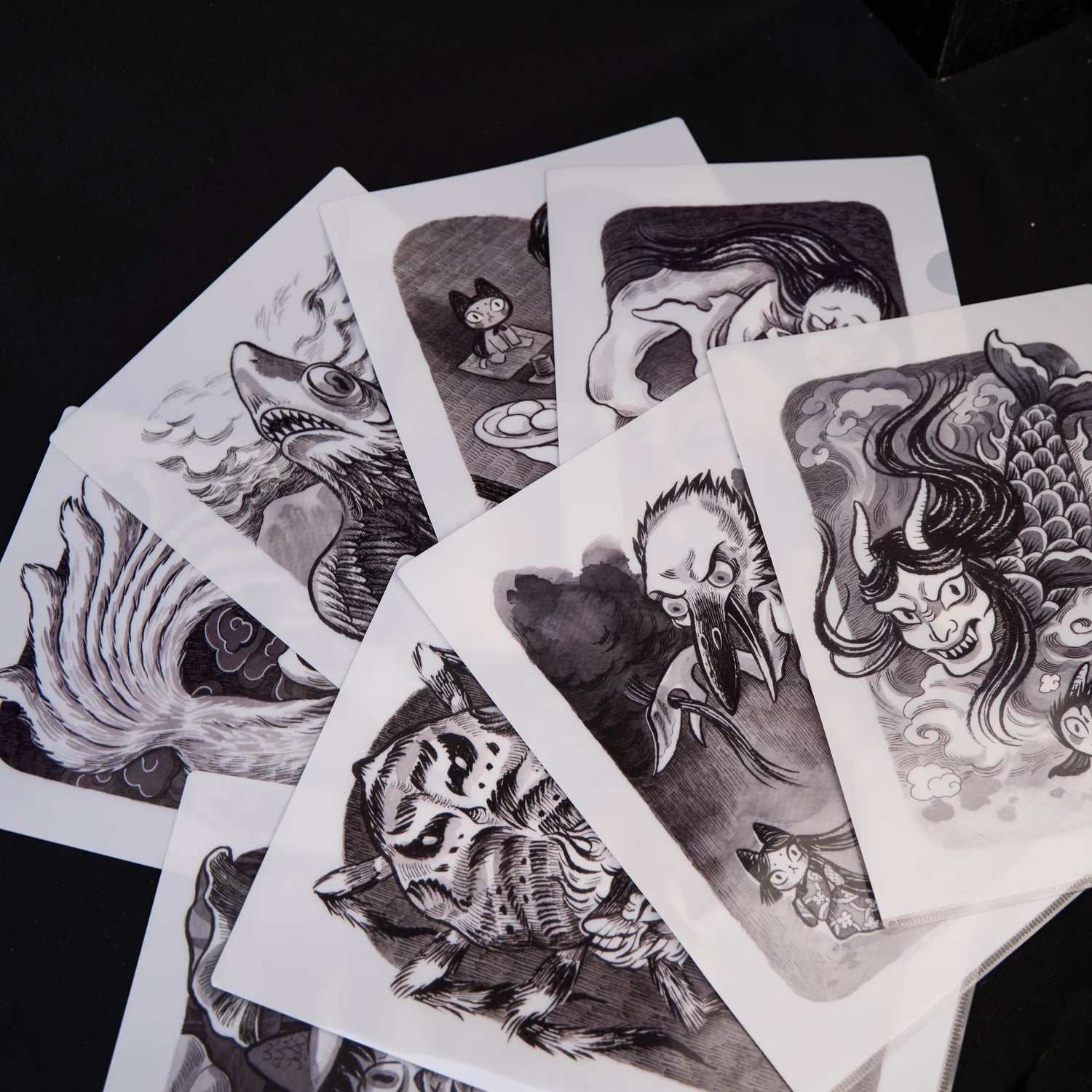 Sketches and drawings of various subjects, including a bird, demon, cat, and woman with long hair, part of BADMEAW Print SLEEVES: NINE A4 DESIGNS.