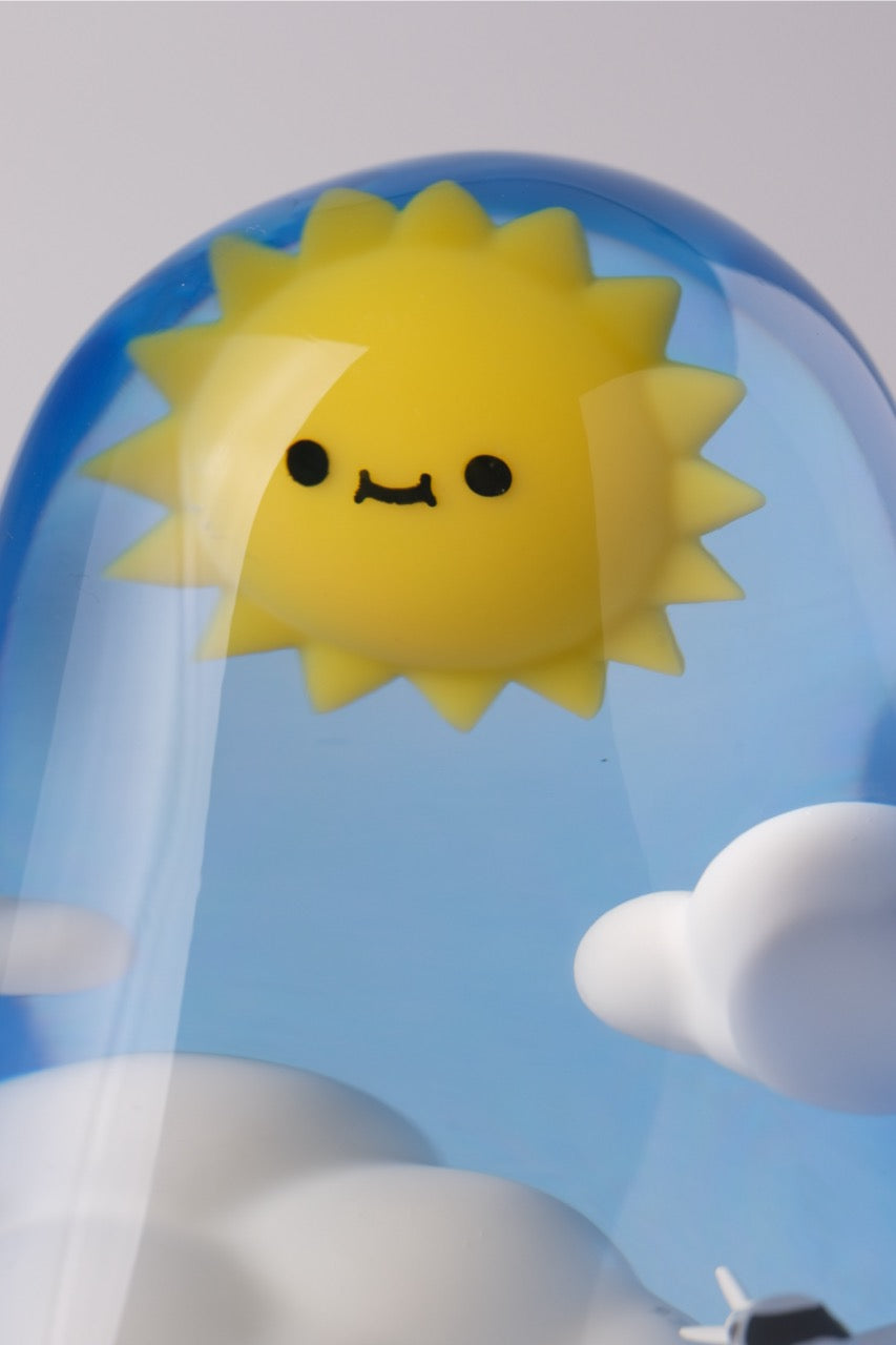 Sky Guy by Sad Salesman: A whimsical display dome featuring a cartoonish smiling sun with clouds, ideal as a playful desk ornament or decorative toy.