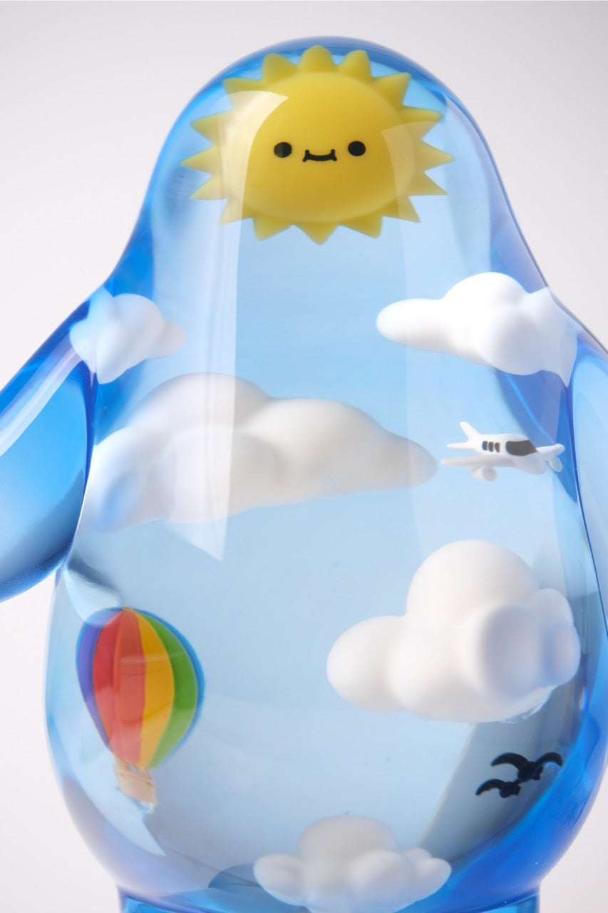 Sky Guy by Sad Salesman: A penguin-shaped vinyl figure with suspended weather elements, including a sun, clouds, airplane, hot-air balloon, and birds.