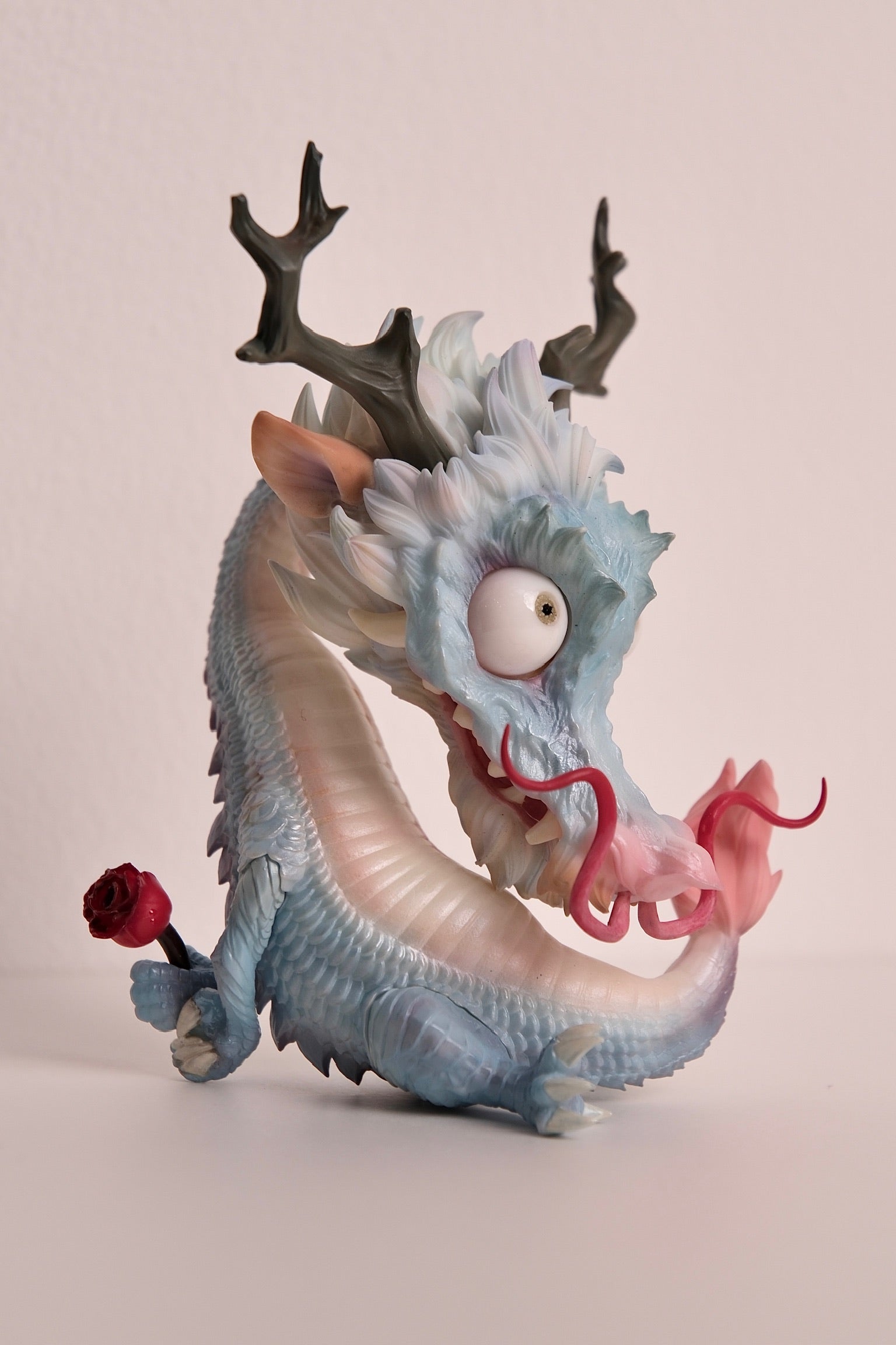 A toy dragon with antlers and a rose, part of the Chinese Zodiac - Year of Dragon - Preorder collection.