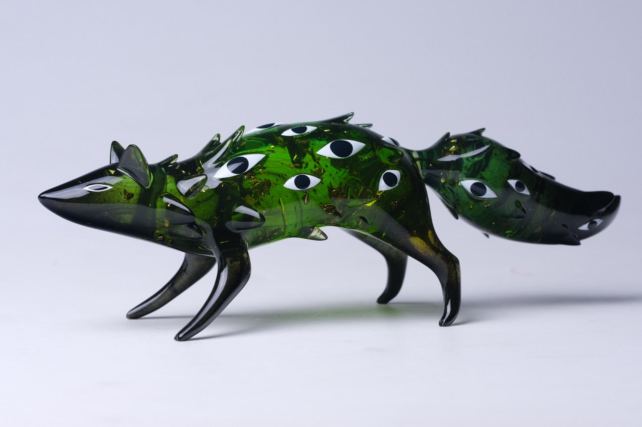 Bogwalker Oracle by Faunwood: A 10cm stylized, translucent fox-like sculpture with multiple eye motifs, made from high-grade resin. Limited edition of 100 pieces.