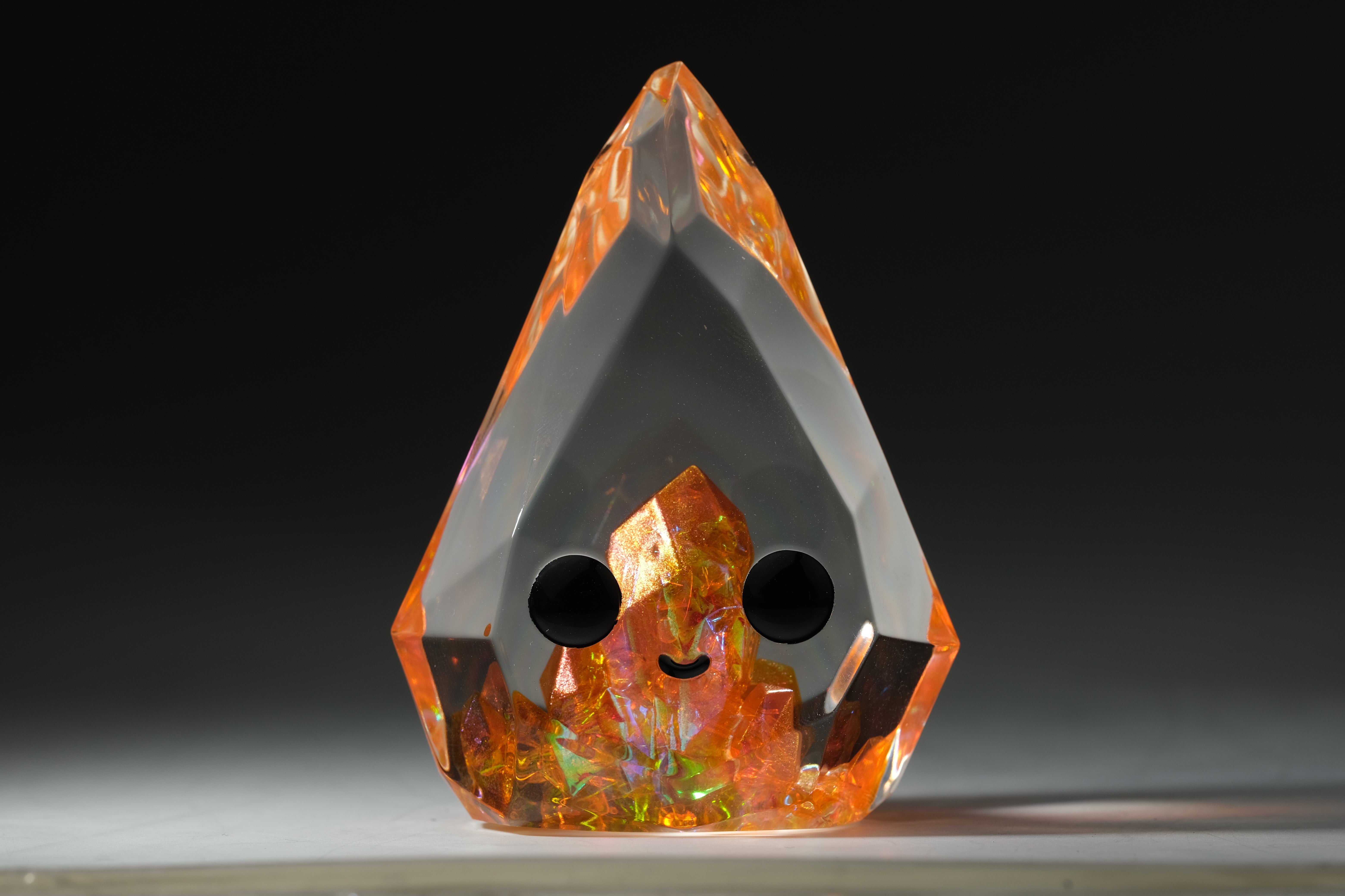 Fire Opal Prismite by Yutoos, a 3.5 resin art piece, limited edition of 50, featuring a sleek black circle design.