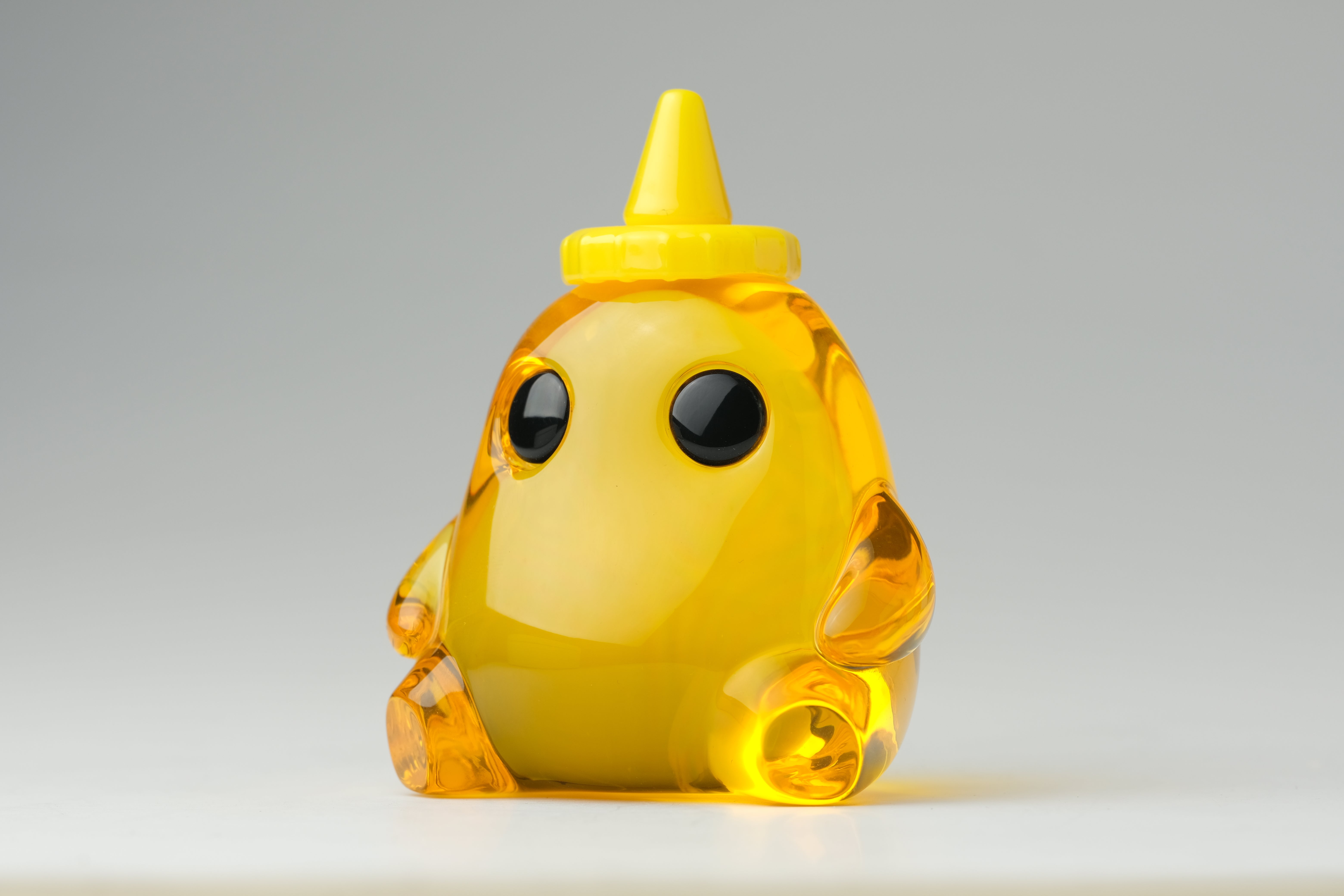 Honey Stubby by The Lostlings, a 3.5 resin toy featuring a cartoonish animal figure with a yellow cone shape, limited to an edition of 50.