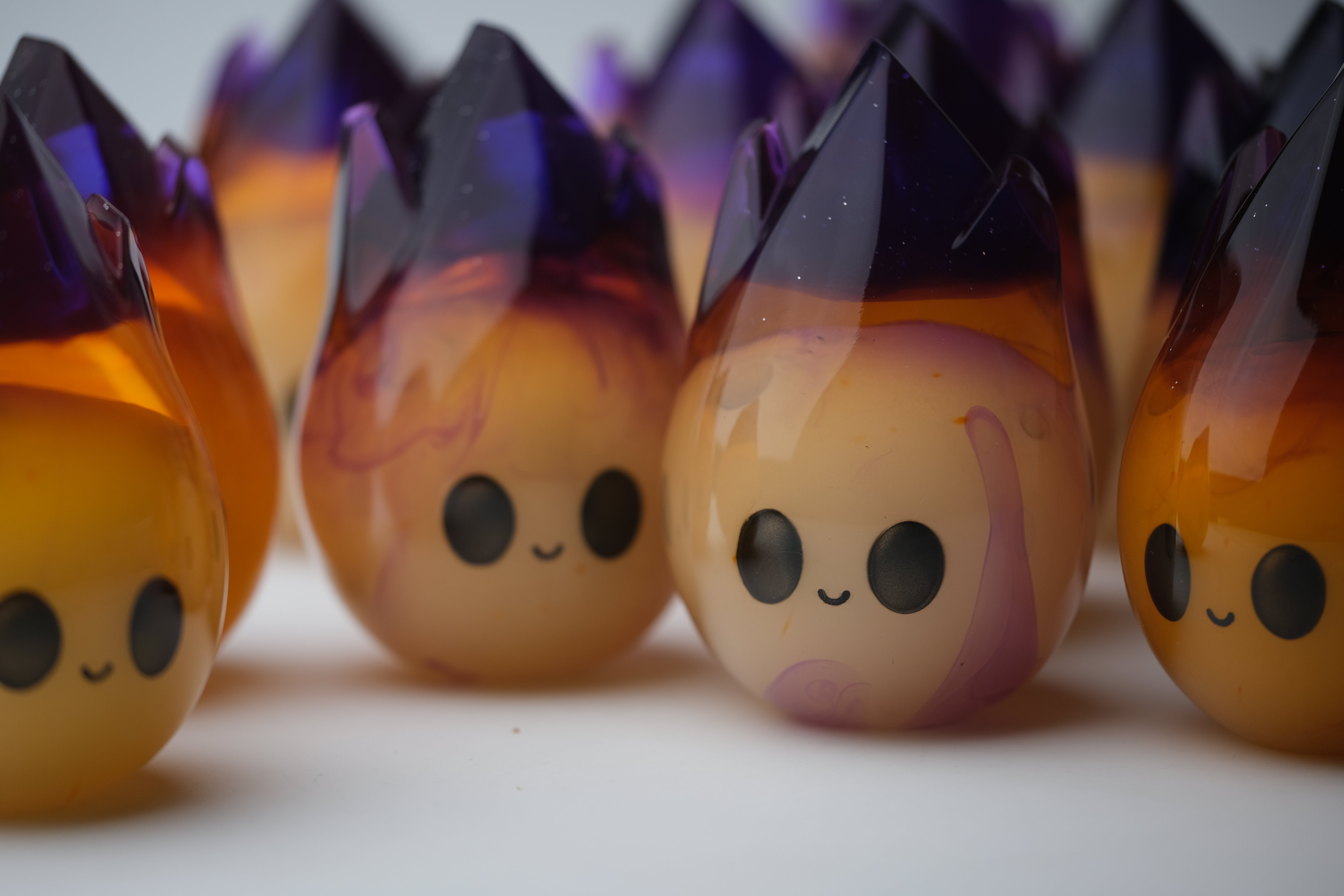 Cosmite by Yutoos, a 3.5 resin art toy, features a close-up of a cartoonish smiley face, part of a limited edition of 50.