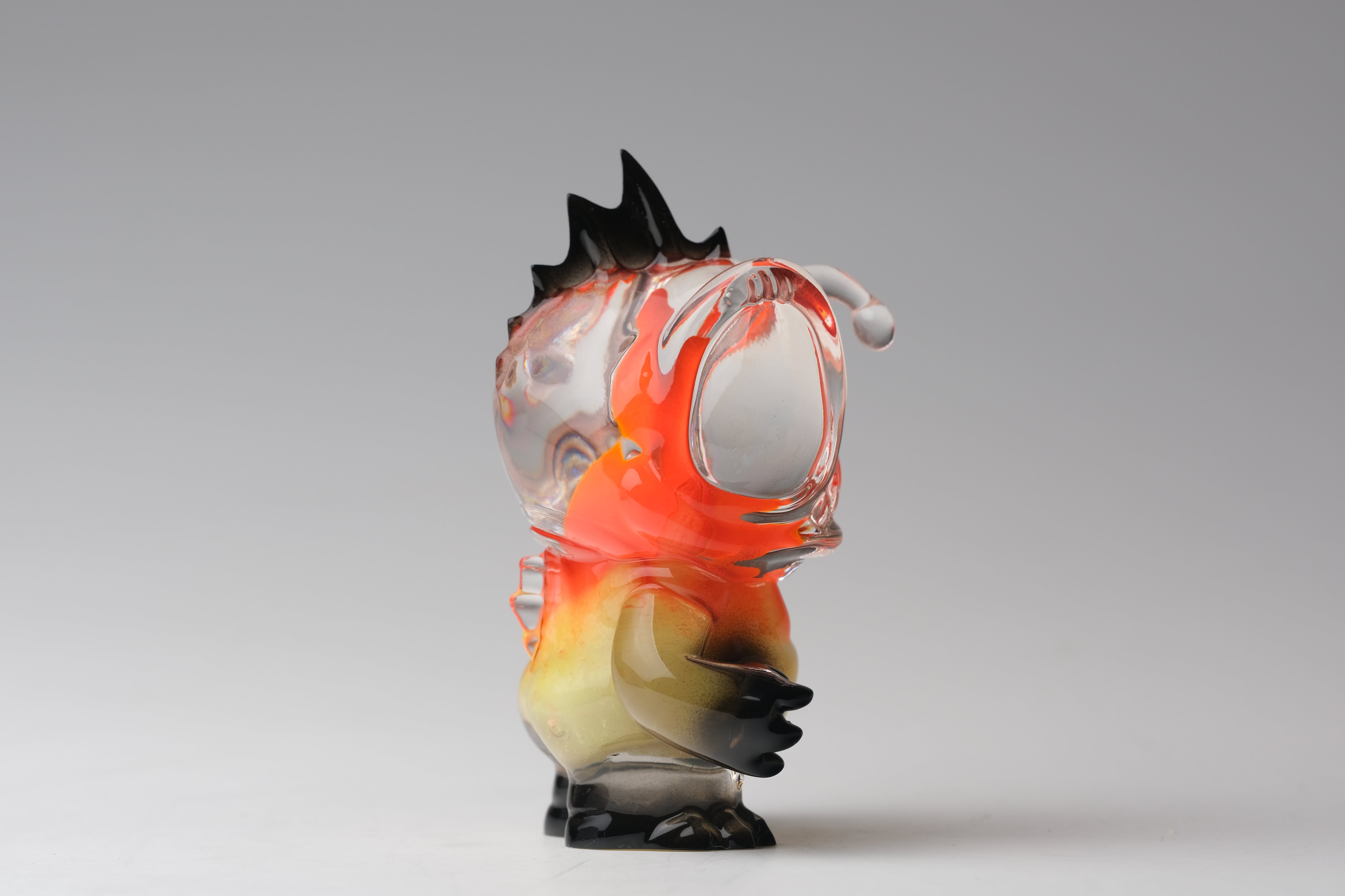 Angie Evo - Chicago Fire by 5th Turtle: A 3.5 hand-blown glass sculpture with a fiery, transparent head and black spikes, limited to 50 pieces.
