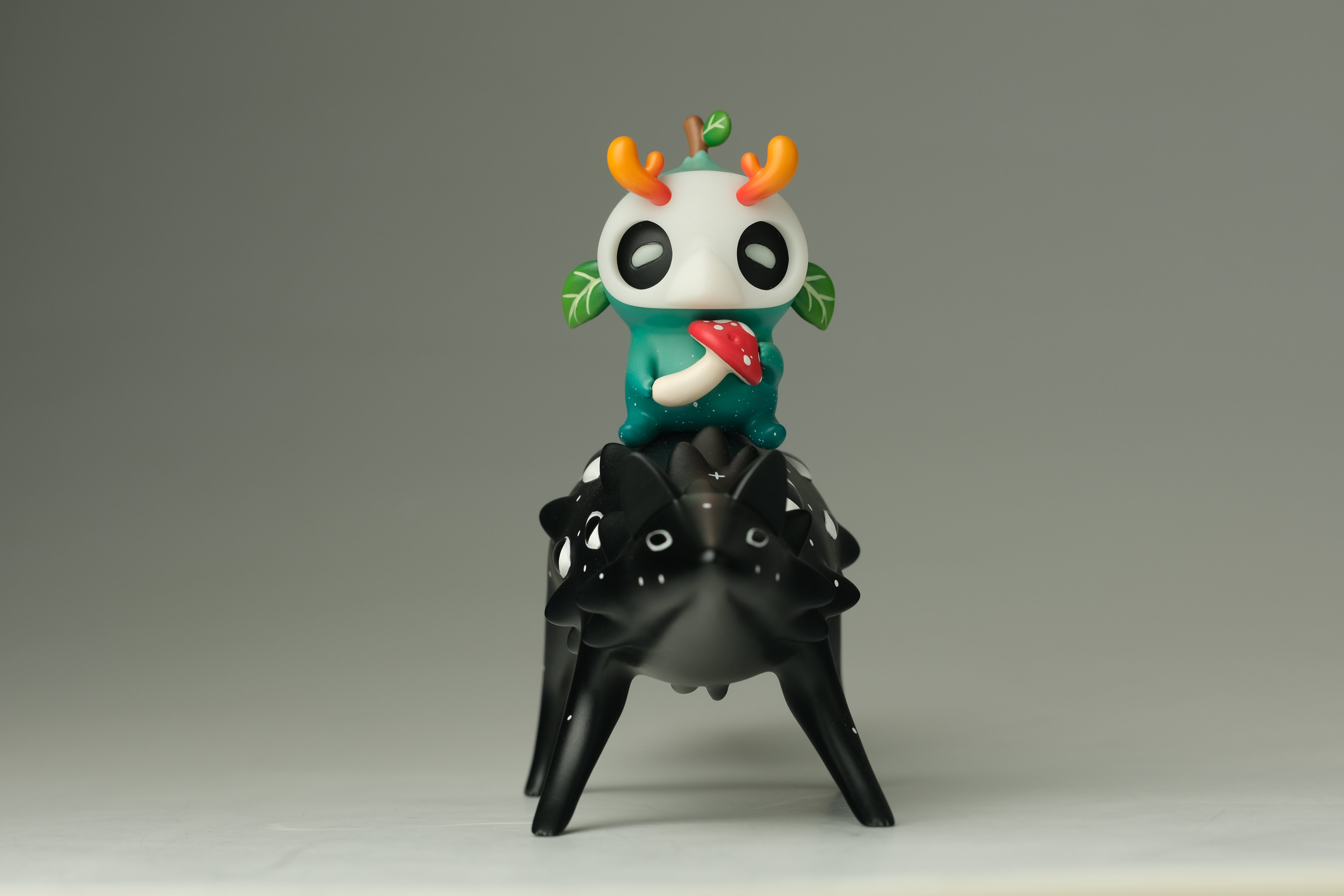Oracle & Muffin by Faunwood x Madkids: A stylized vinyl art toy duo featuring a teal creature with mushroom, stacked on a black four-legged figure. Limited edition.