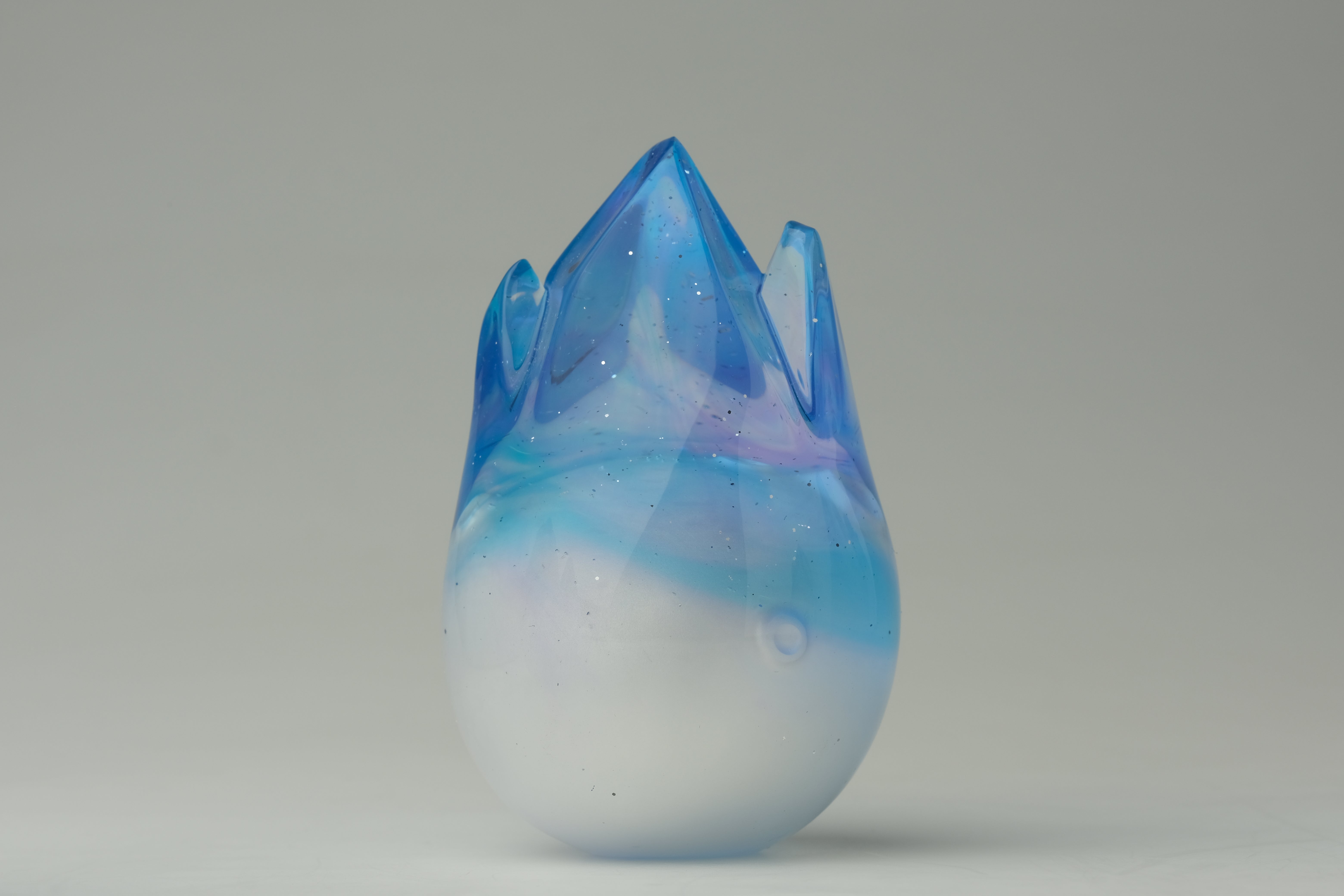 Aurora Cosmite by Yutoos, a hand-blown glass art piece with milky-white base and translucent blue crown, 3.5, edition of 50, each unique.