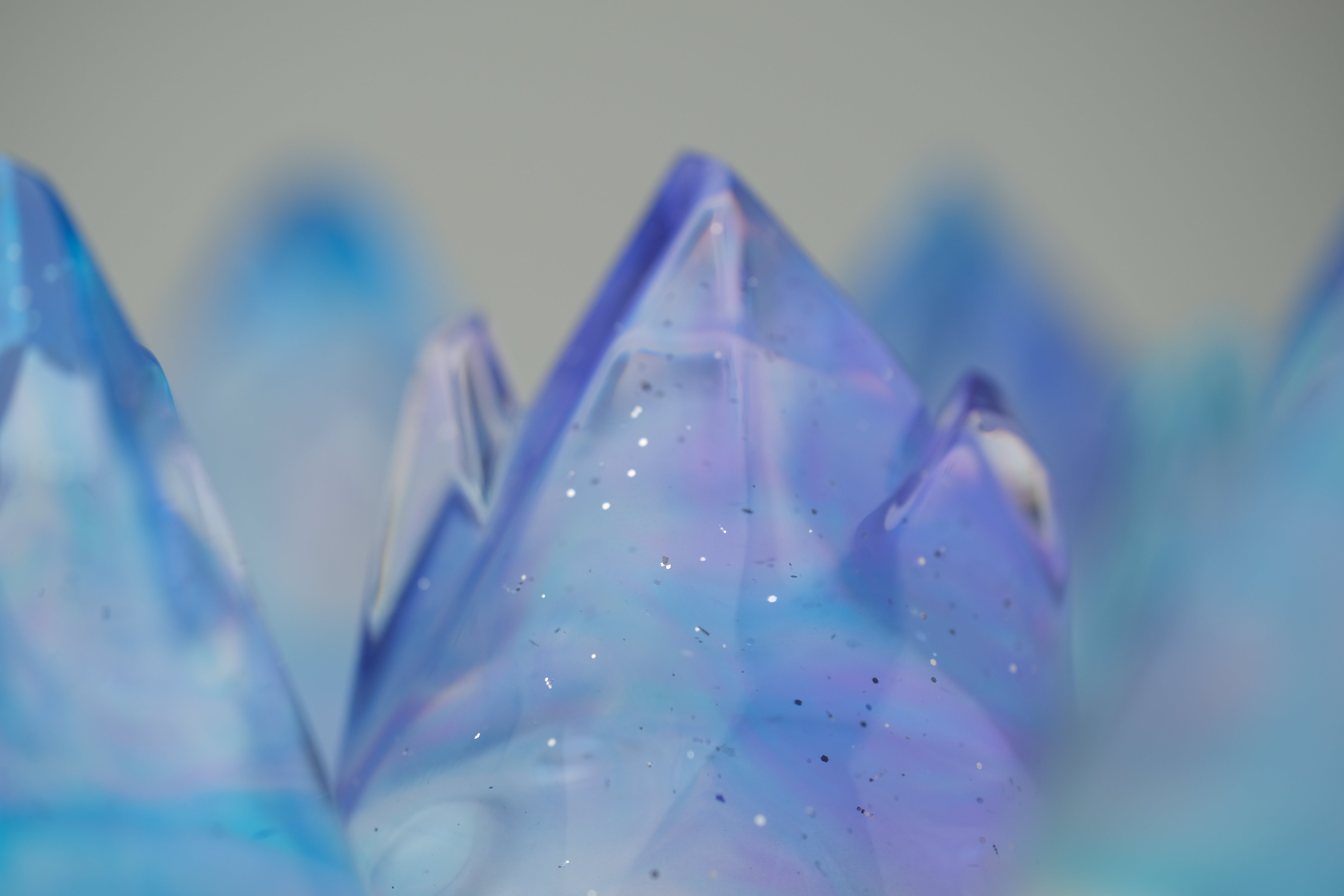 Aurora Cosmite by Yutoos: A 3.5 resin art piece with iridescent mountain-like peaks, featuring unique glittered surfaces in an edition of 50.