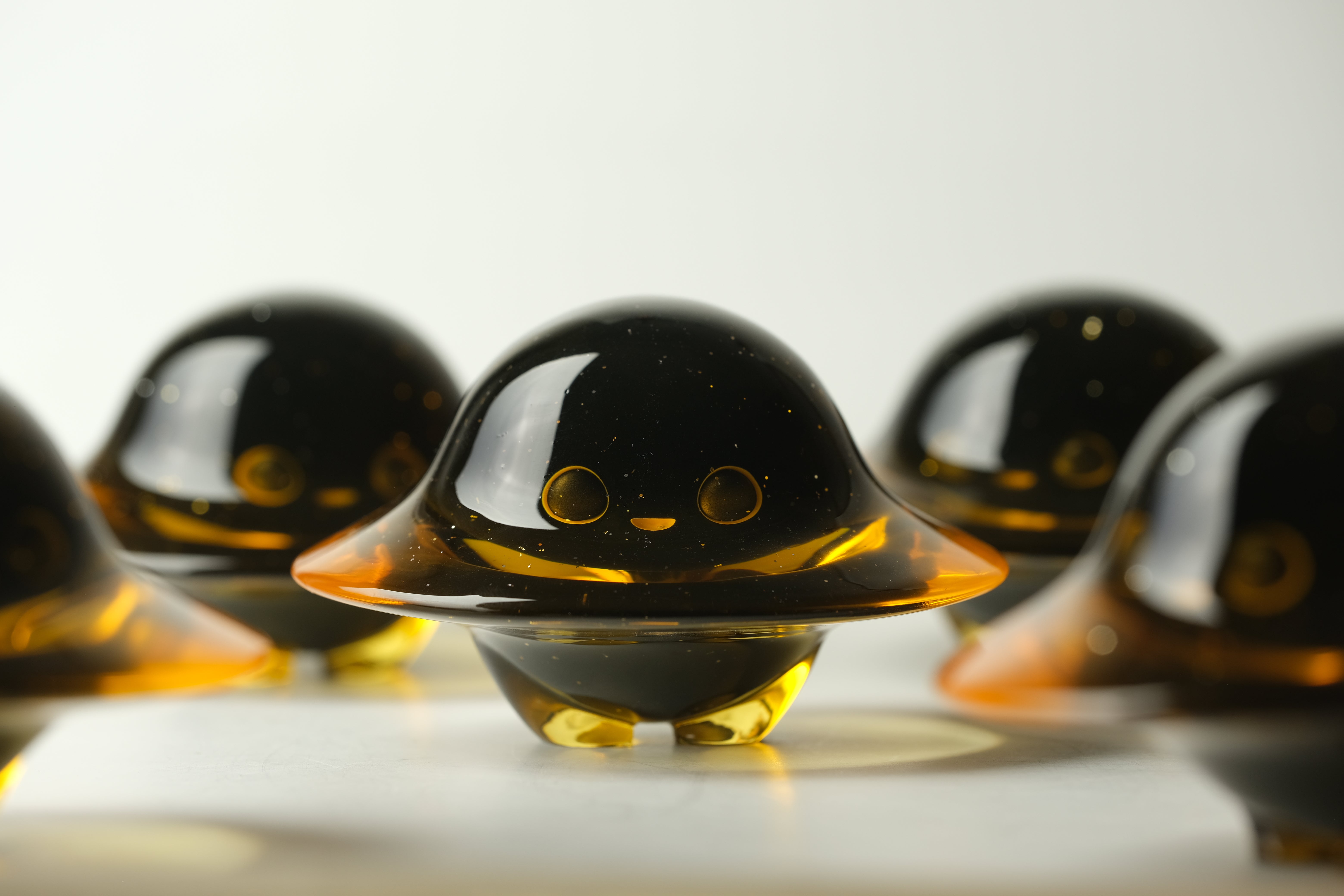 Darkmite by Yutoos: Cute, alien-like resin figurines with sparkling black tops and amber bases, 3.5 tall, limited edition of 50.