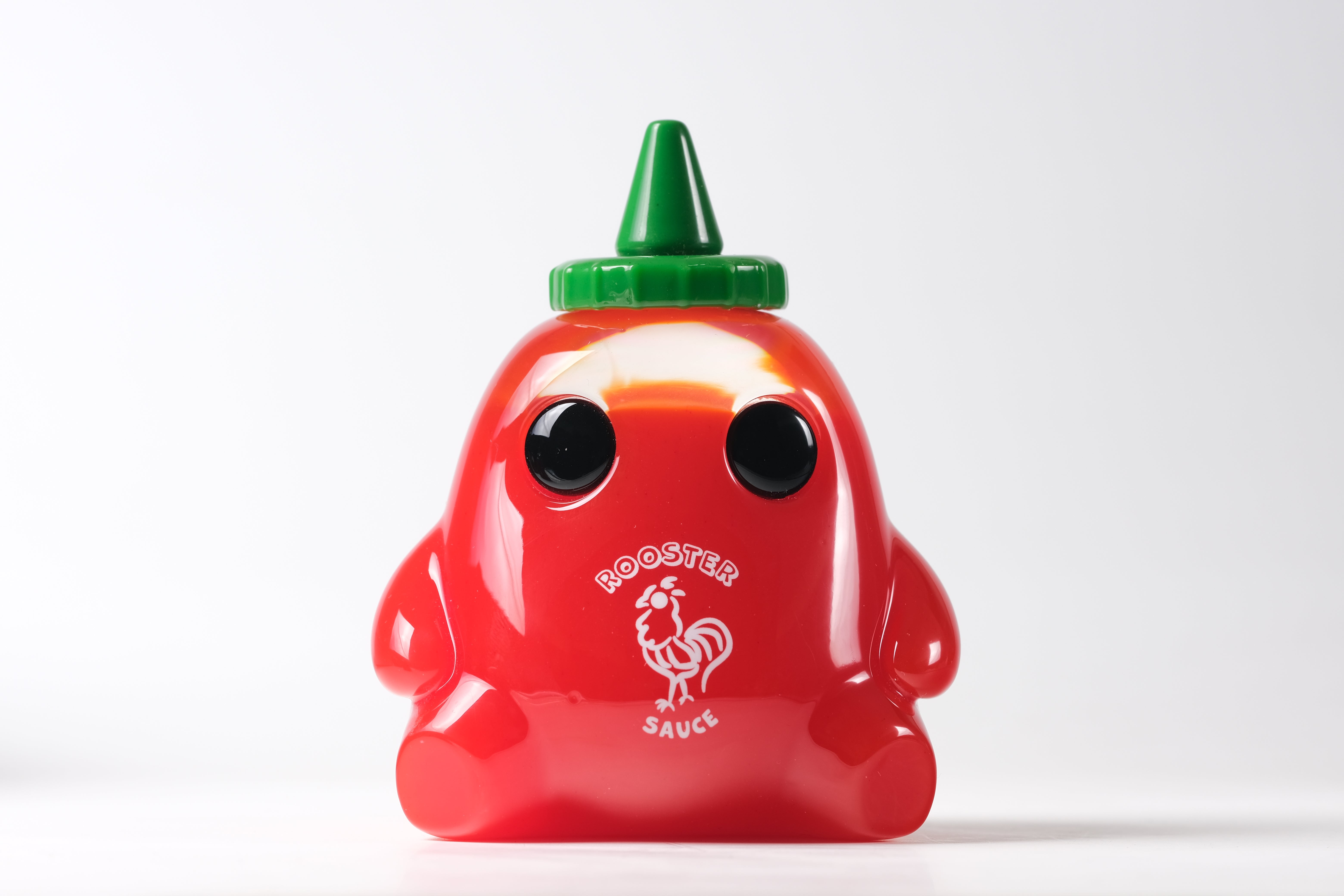 Stubby Rooster Sauce by The Lostlings: A 3.5 bright-red resin figurine with black eyes, green twist-top, resembling a cartoonish bottle. Limited edition of 50.