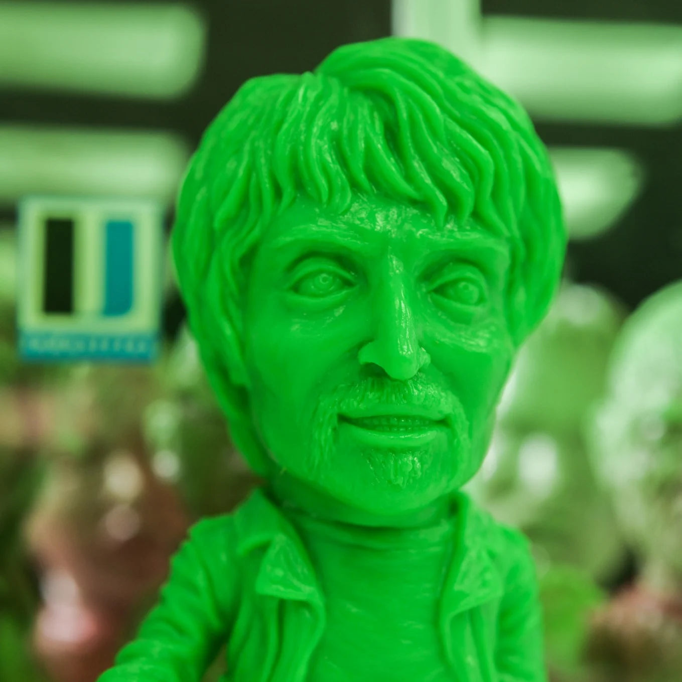 Green vinyl bust from ZOMBI: DAWN OF THE DEAD Who Goes There Blind Box Series, depicting a man with tousled hair and stubble, designed by Naoki Okamoto.