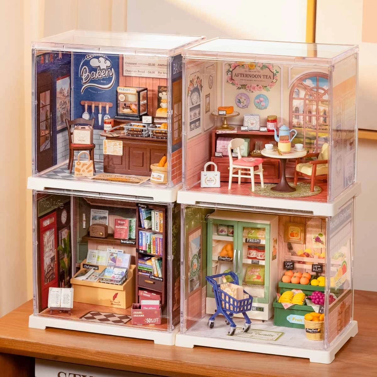 Rolife Mini Super Creator DIY Miniature House - Shop Series featuring bakery, tea parlor, grocery, and bookshop dioramas in clear display cubes, perfect for collectors.