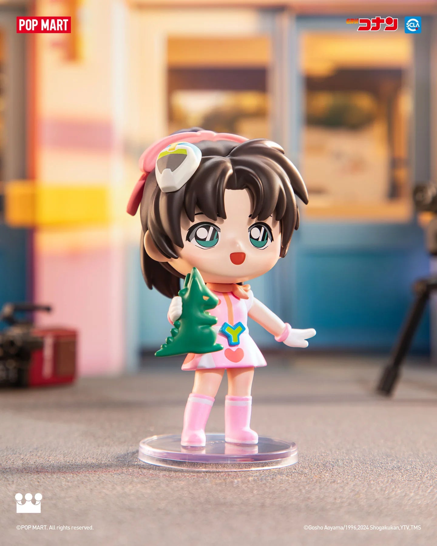 A figurine of a girl holding a Christmas tree from Detective Conan Carnival Blind Box Series.