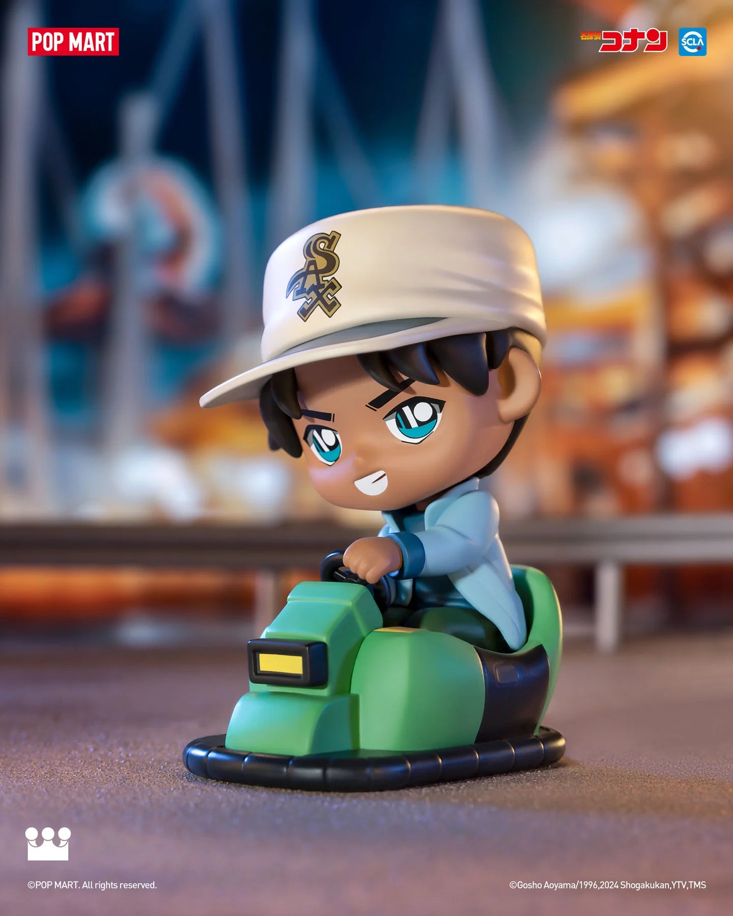 Detective Conan Carnival Blind Box Series: a toy figurine of a boy on a bumper car, a toy vehicle with a hand on the steering wheel.