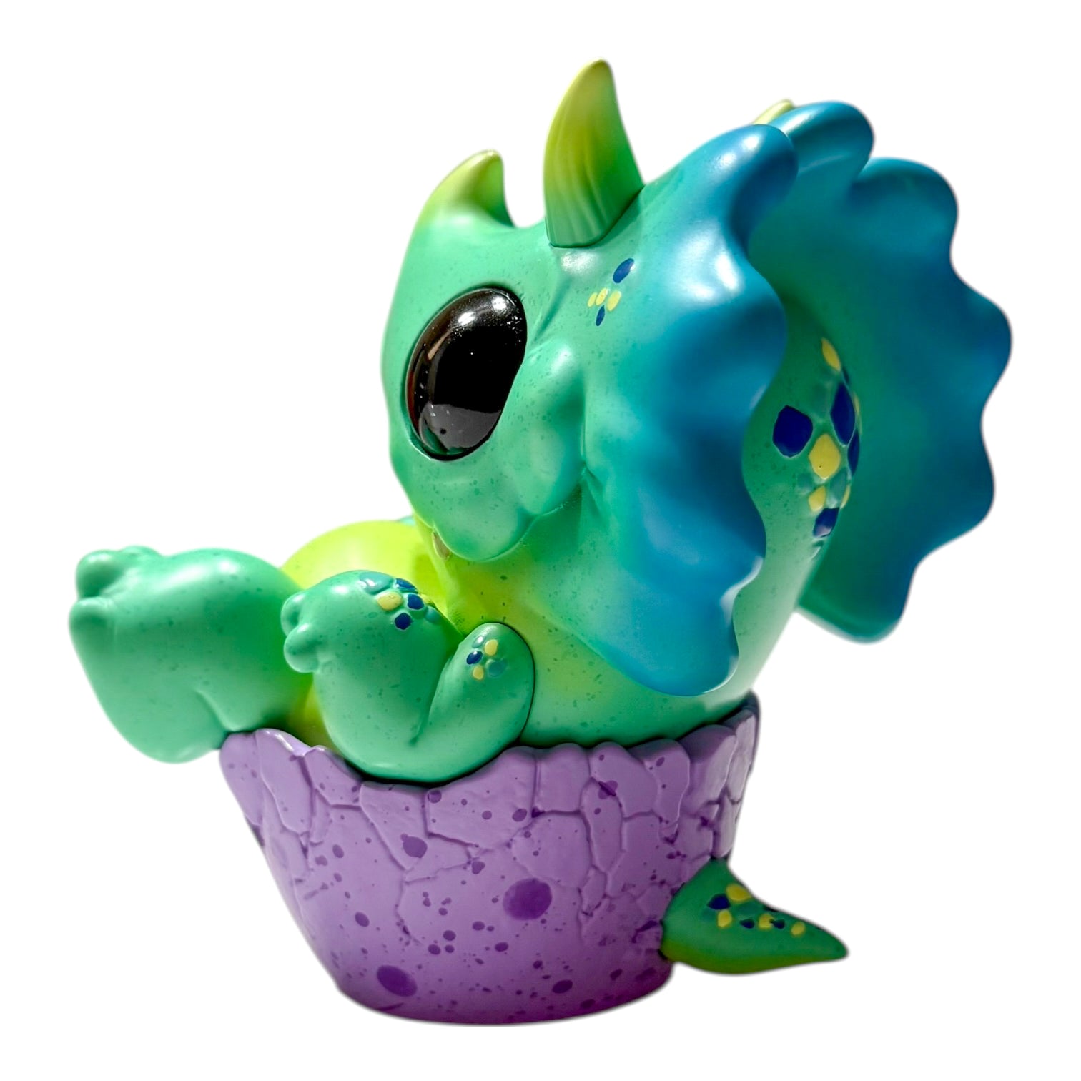 Seaside Eggtoof by Chris Ryniak - Preorder: A green, chibi-style dinosaur in a purple eggshell. Limited edition resin figure, 4.5x4, shipping Dec 2025.