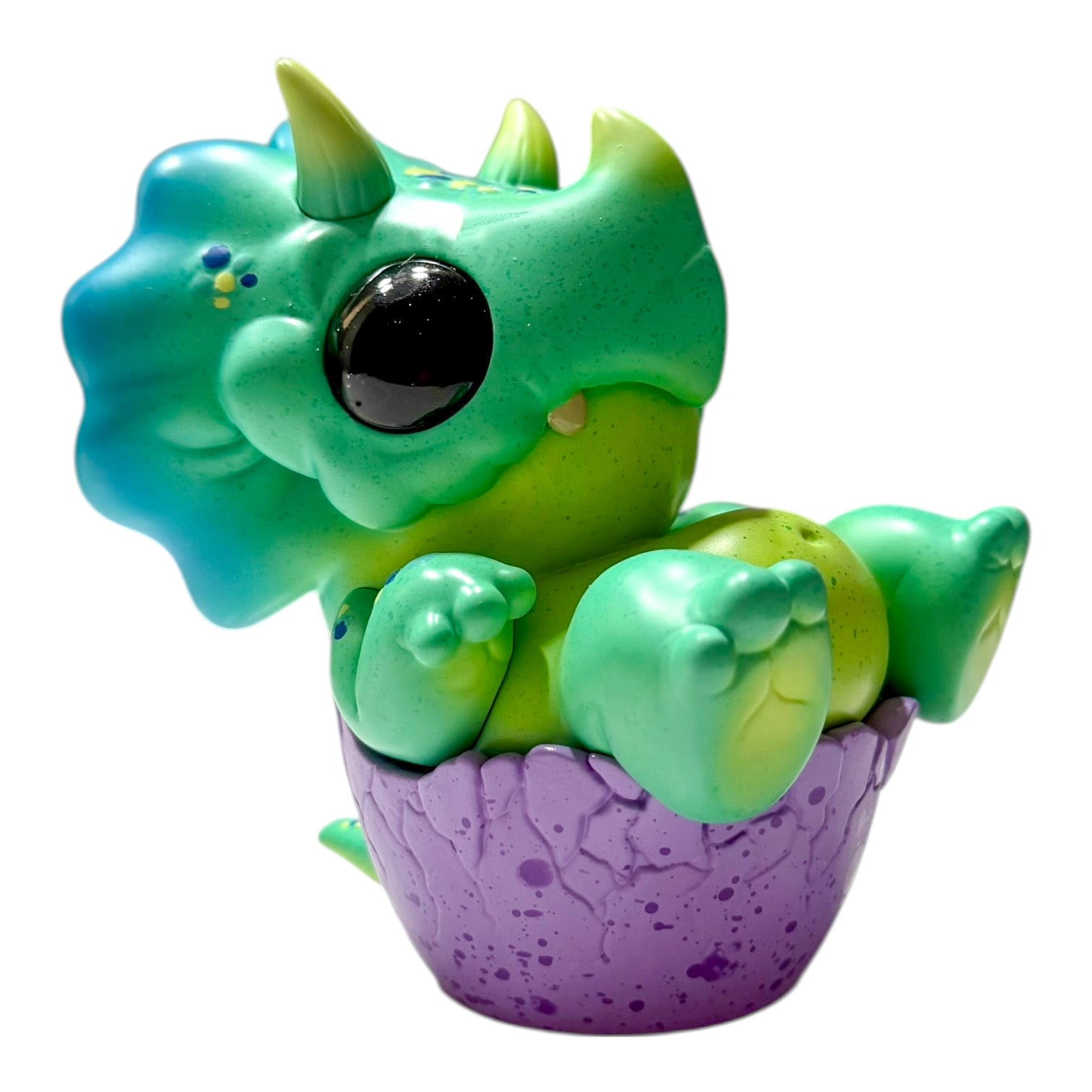 Seaside Eggtoof by Chris Ryniak - Preorder; a cute, green dinosaur figurine sitting in a speckled eggshell, limited edition collectible resin toy.
