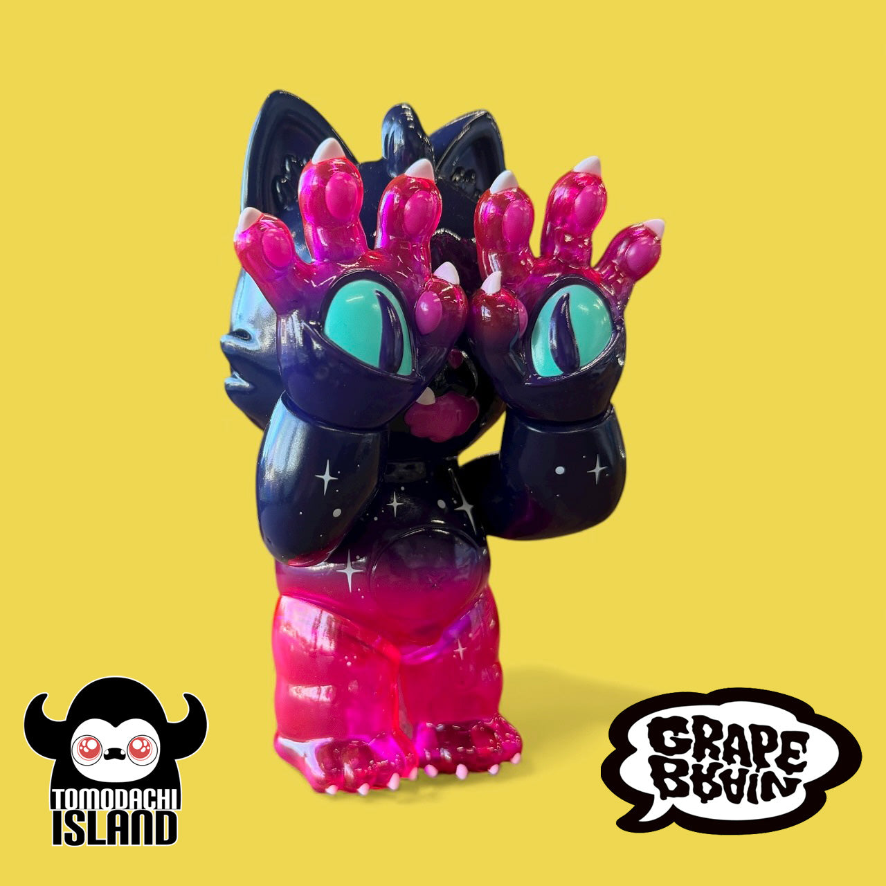 Cosmic Gramps vinyl figure with a cat-like head, star-speckled purple body, and oversized pink paws, showcasing Tomodachi Island x Grape Brain x Prime collaboration.