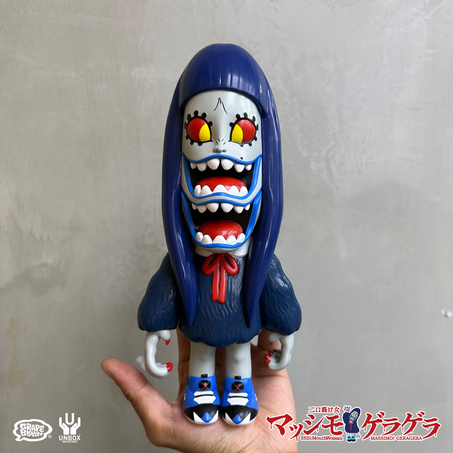 GERA GERA MASSIMO BLUE EDITION: Stylized vinyl toy with three mouths, blue hair, and oversized sneakers, featuring nine articulation points. Preorder collectible by Grape Brain × Unbox Industries.