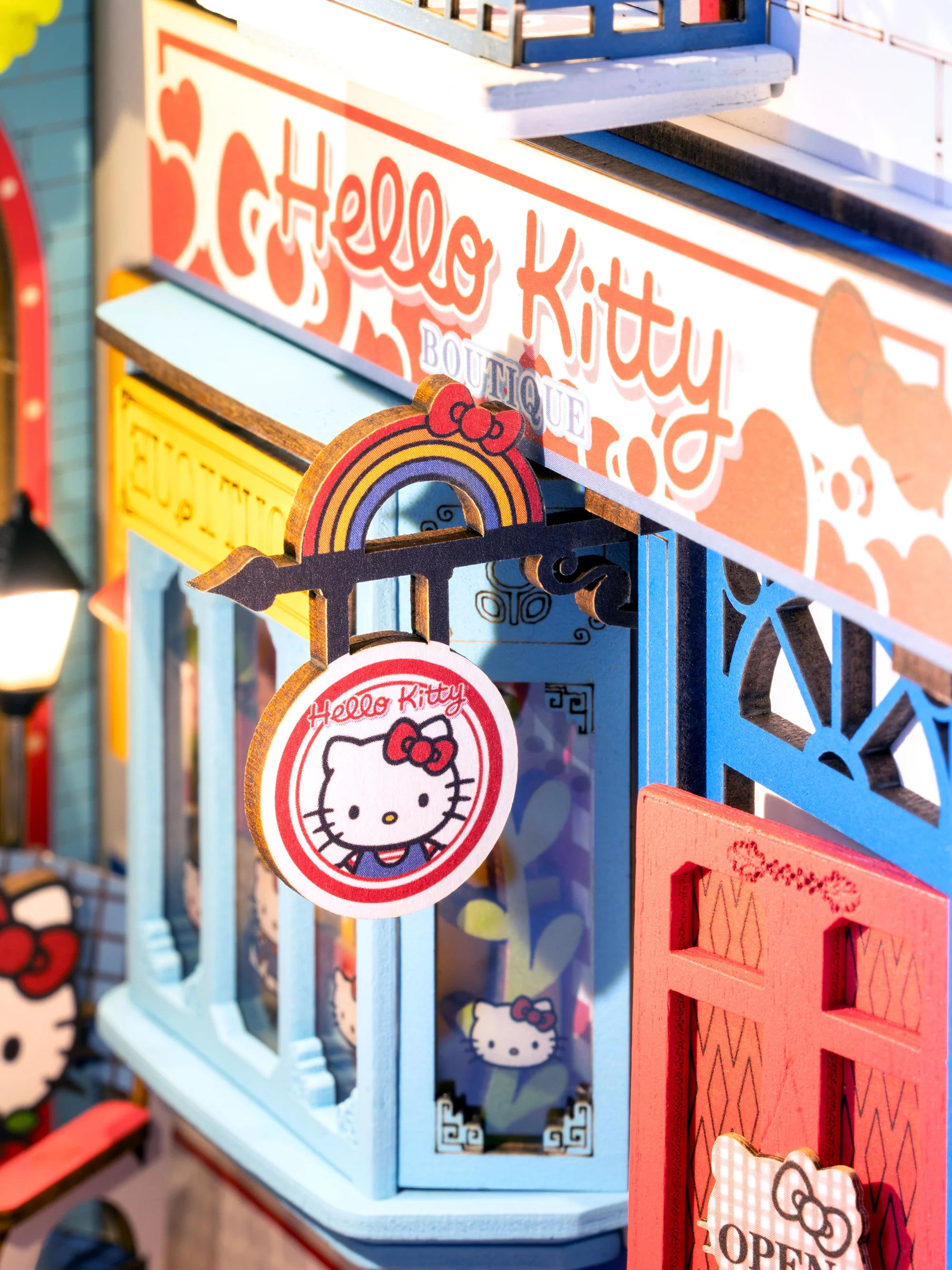 Miniature Hello Kitty® Town Square Booknook model with storefront, display window, and signs, capturing a whimsical DIY shop scene from Strangecat Toys.