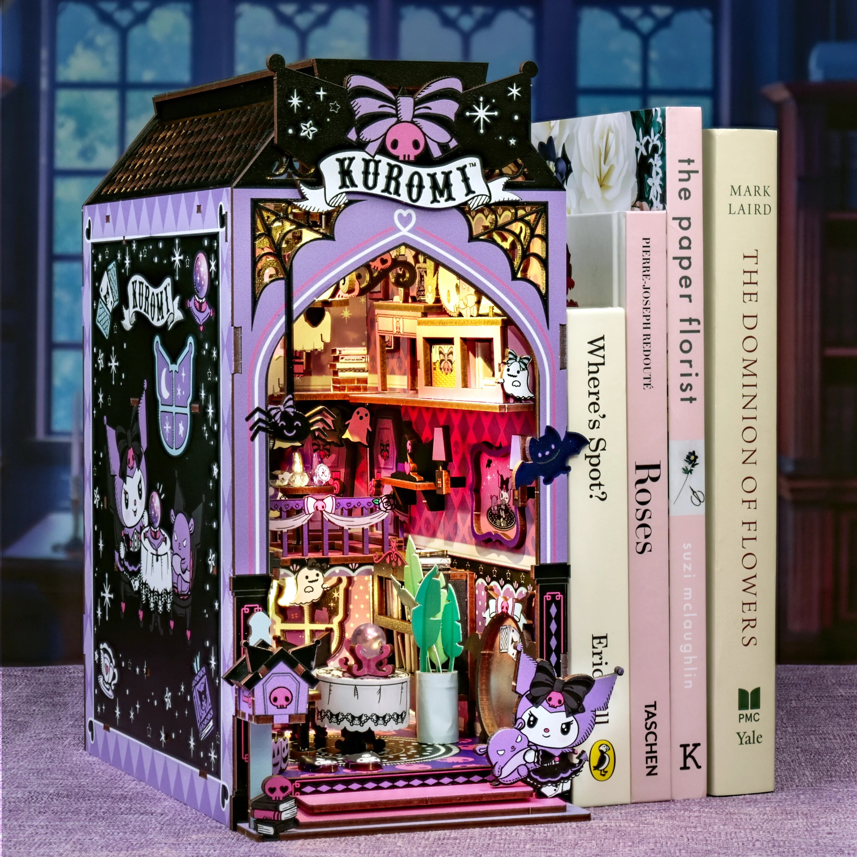 Kuromi™ Spooky House Booknook: Gothic diorama with tiny furniture, cut-out decorations, and LED lighting, serving as a bookend for real books.
