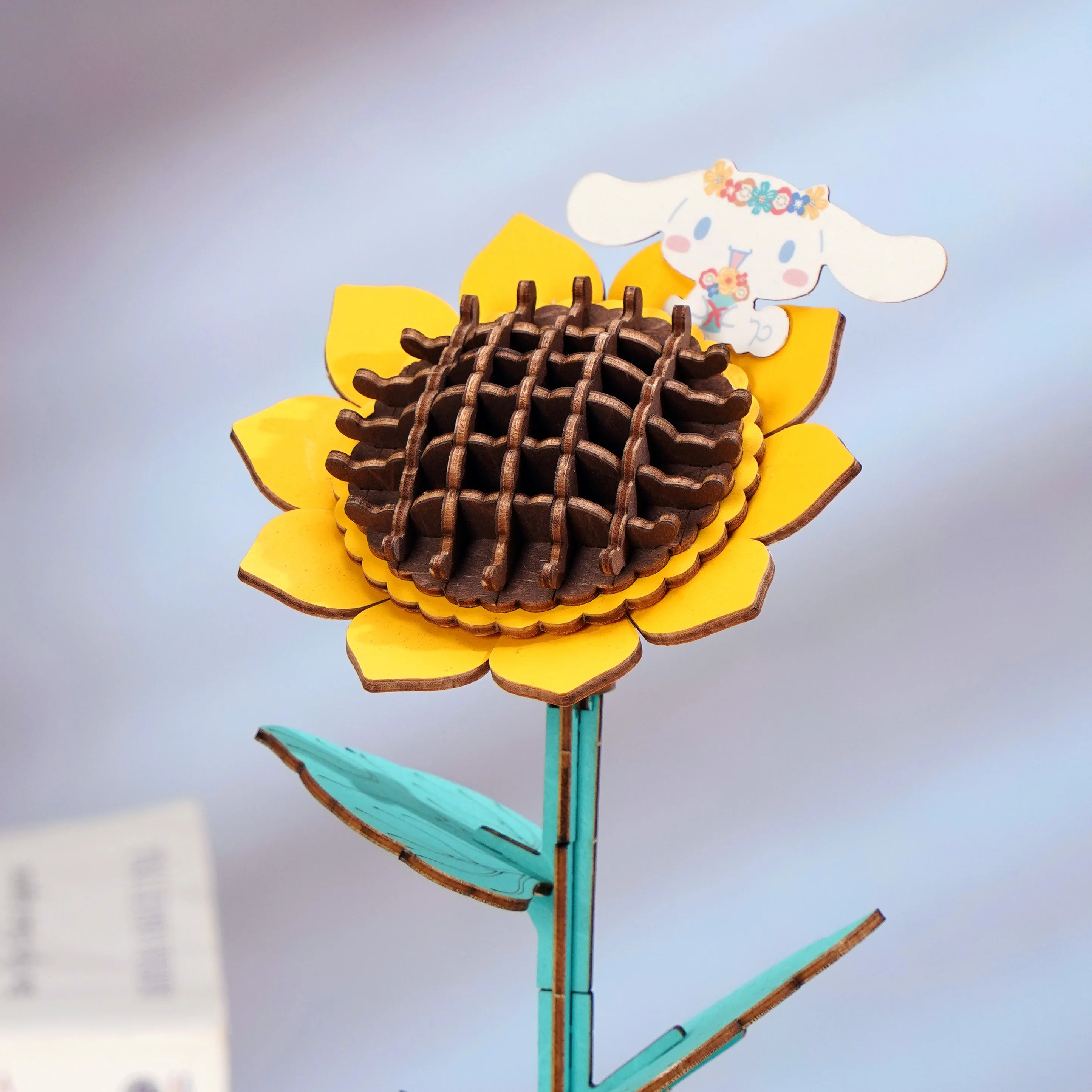 Hello Kitty® and Friends Cinnamoroll Sunflower Wooden Craft Kit features a 3D sunflower puzzle with an adorable Cinamoroll character, perfect for art toy enthusiasts.